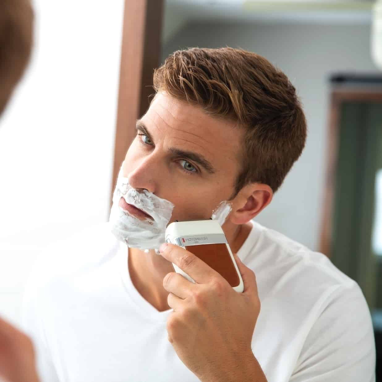 man using a foil shaver for a clean shave