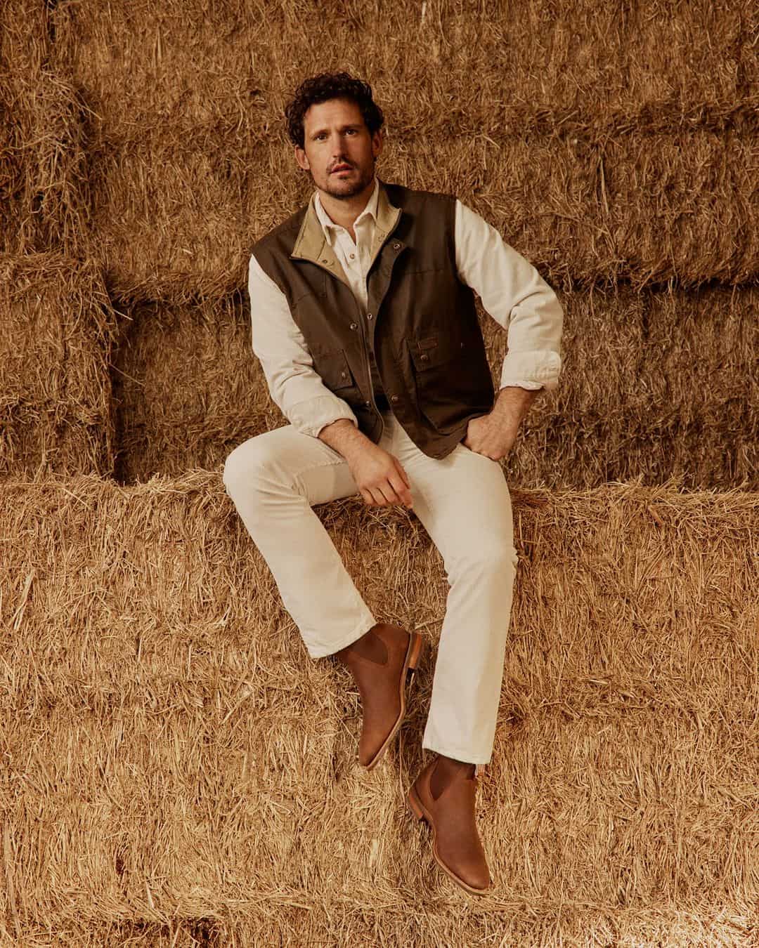 man sitting on a haystack