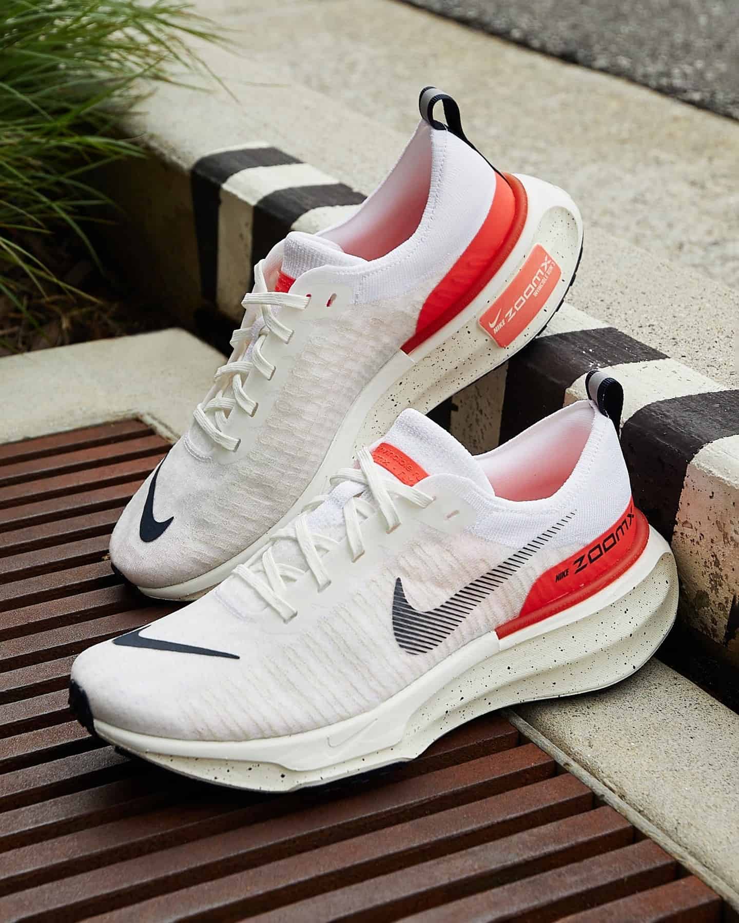 a pair of nike white running sneakers