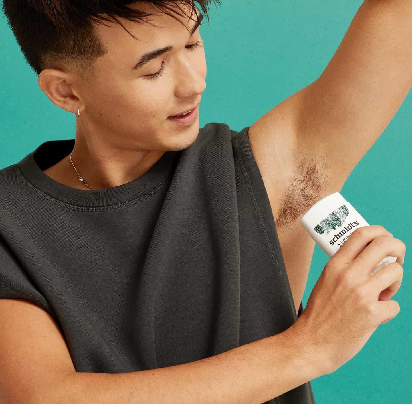 young man using a deodorant