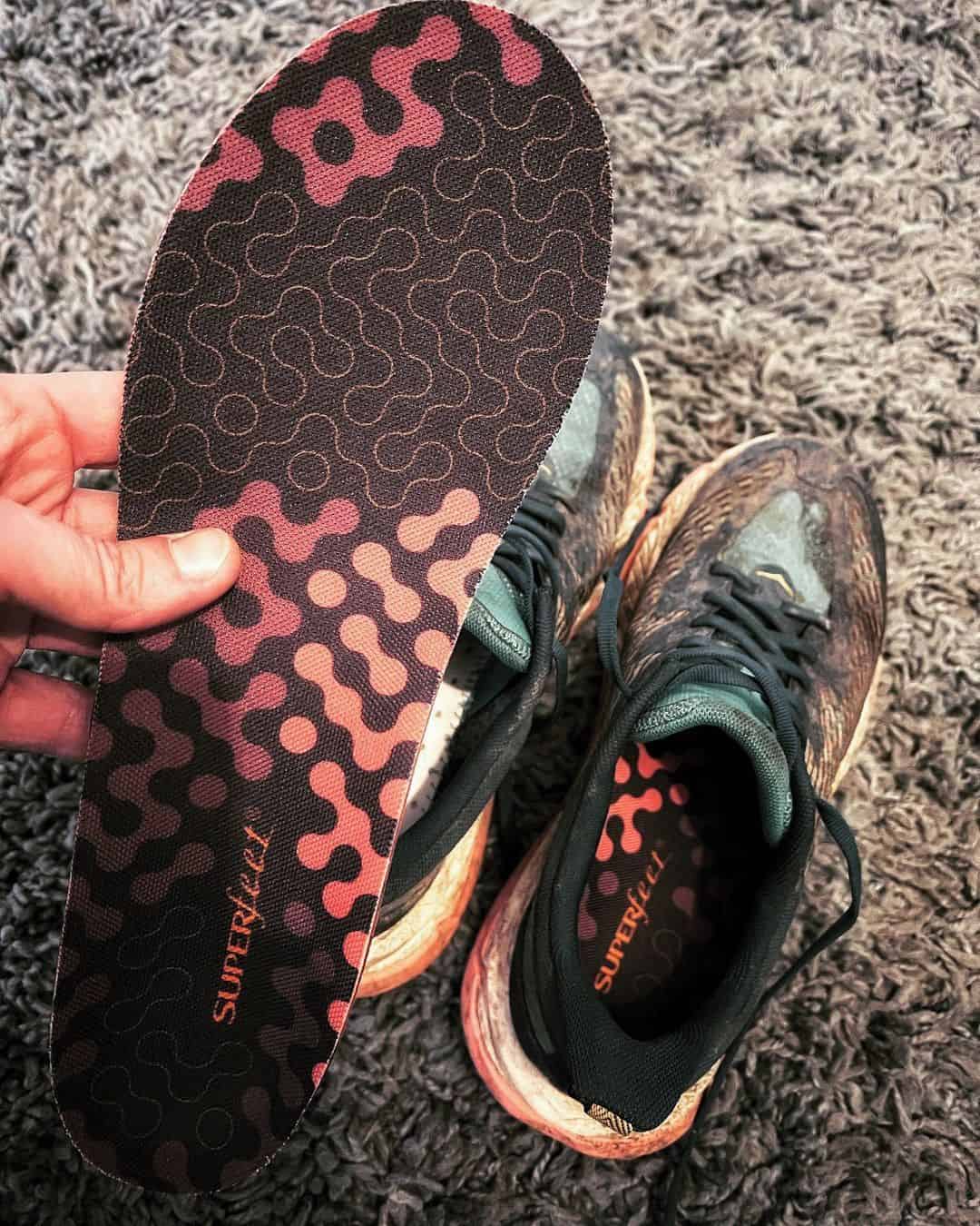 holding an insole for the sneakers