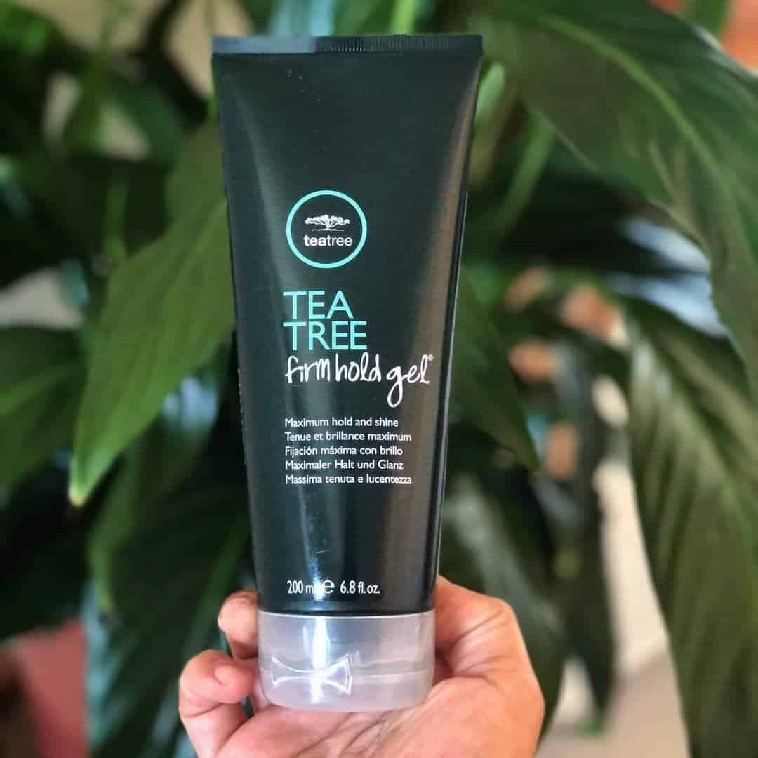holding a tube of tea tree firm hold gel