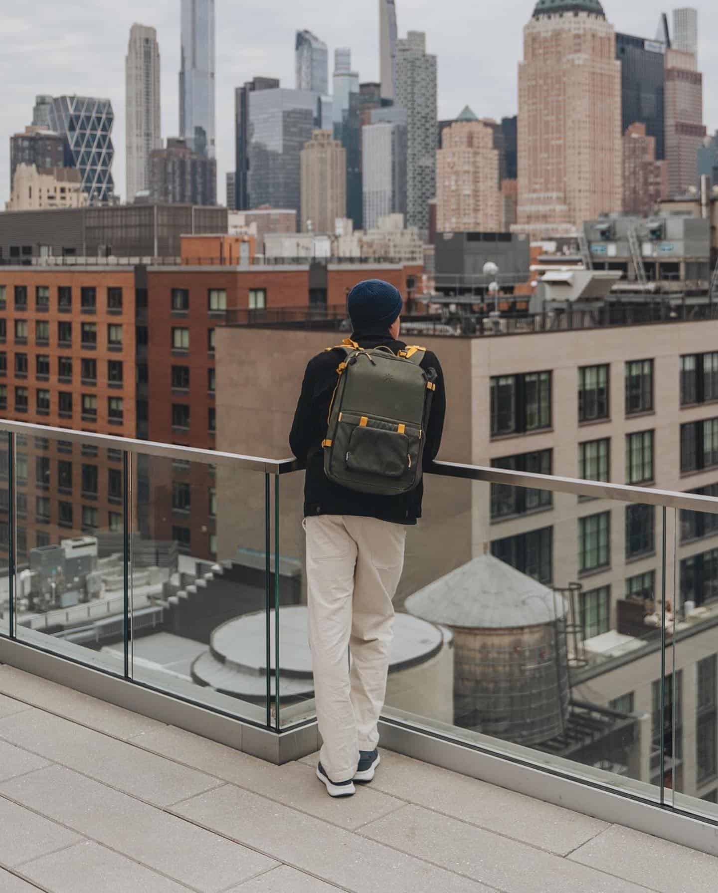 man enjoying the city view from a building rooftop