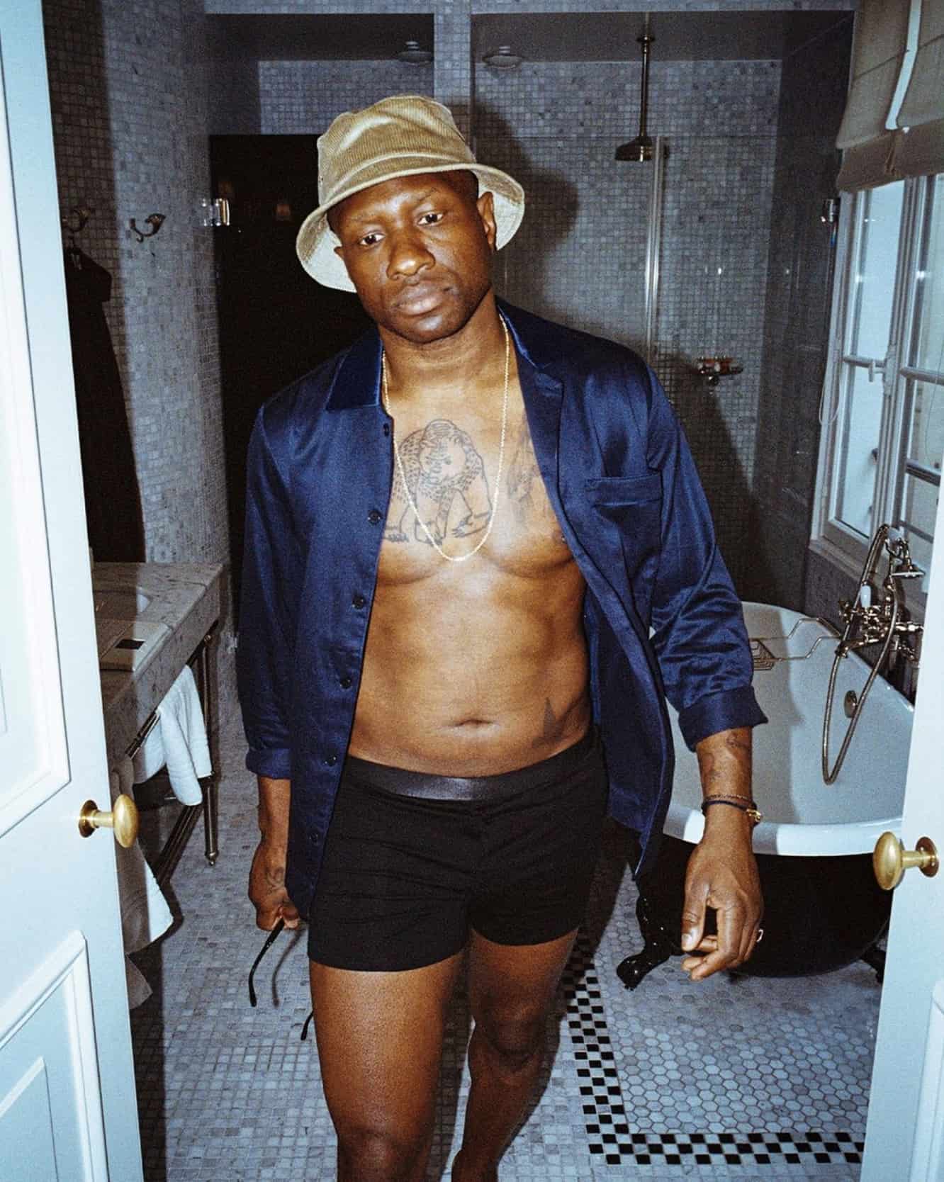 man in bathroom wearing Figaro chain