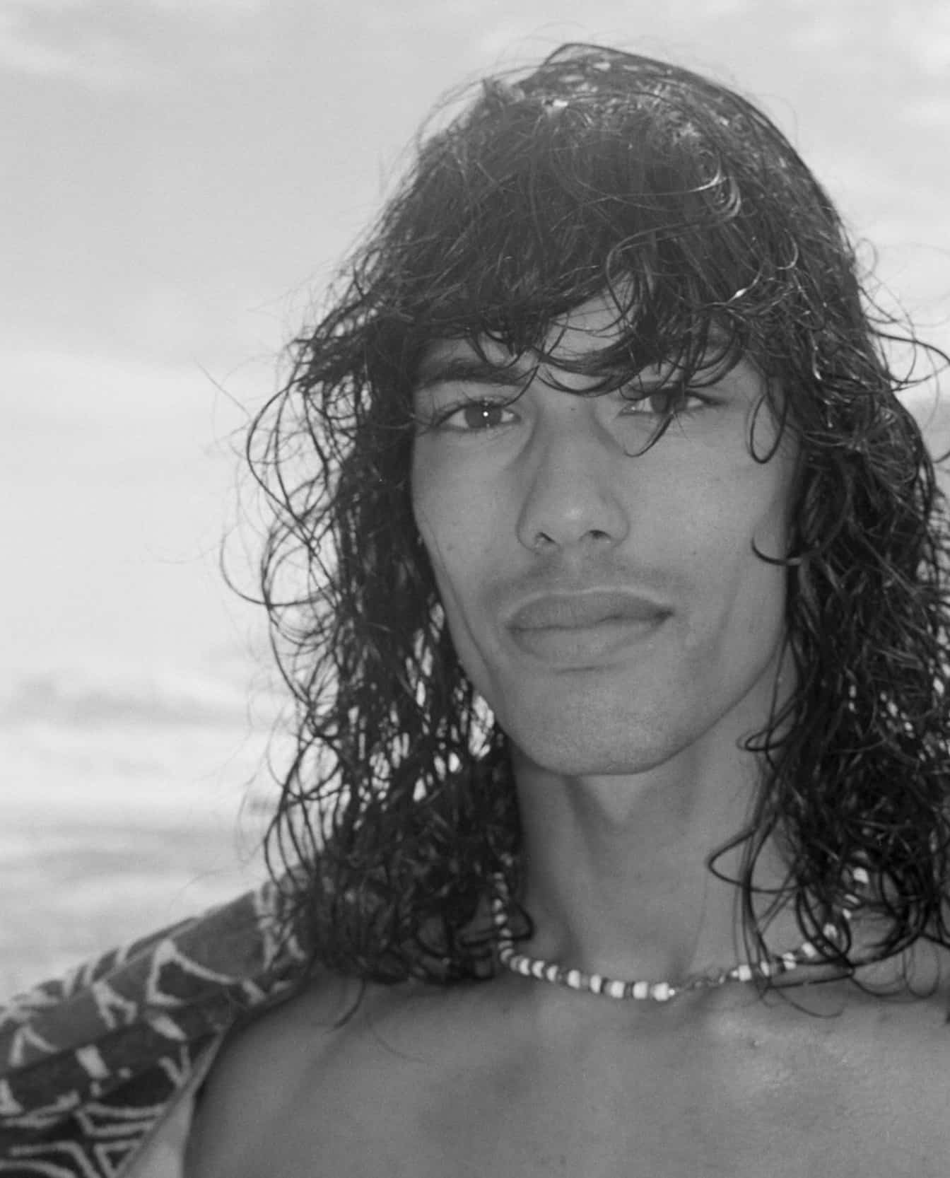 surfer wearing a beaded chain