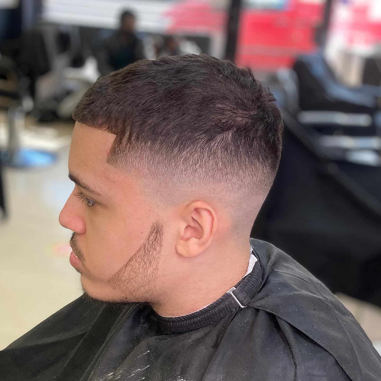 man with a number 6 skin fade haircut and trimmed beard