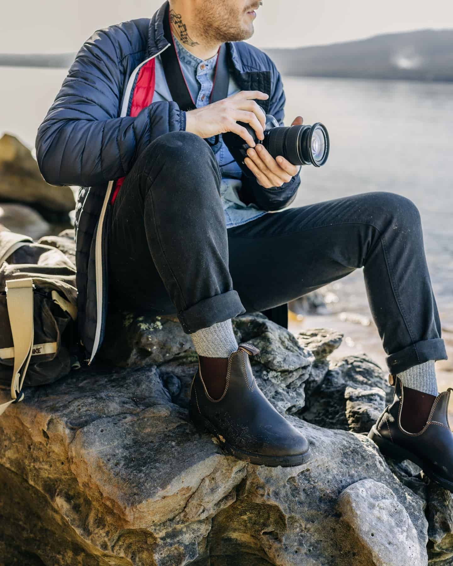 photographer sitting on a rock
