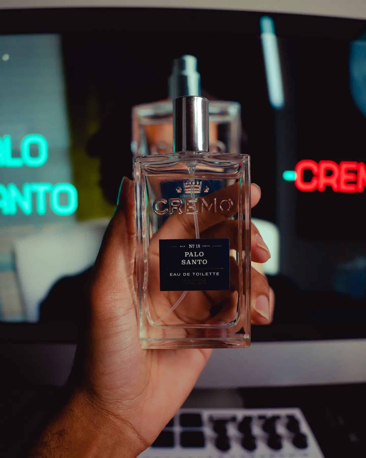 holding a bottle of palo santo by cremo
