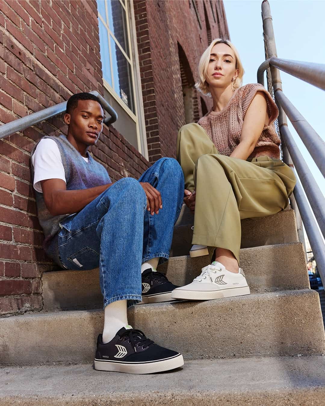 man and woman sitting on the stairs