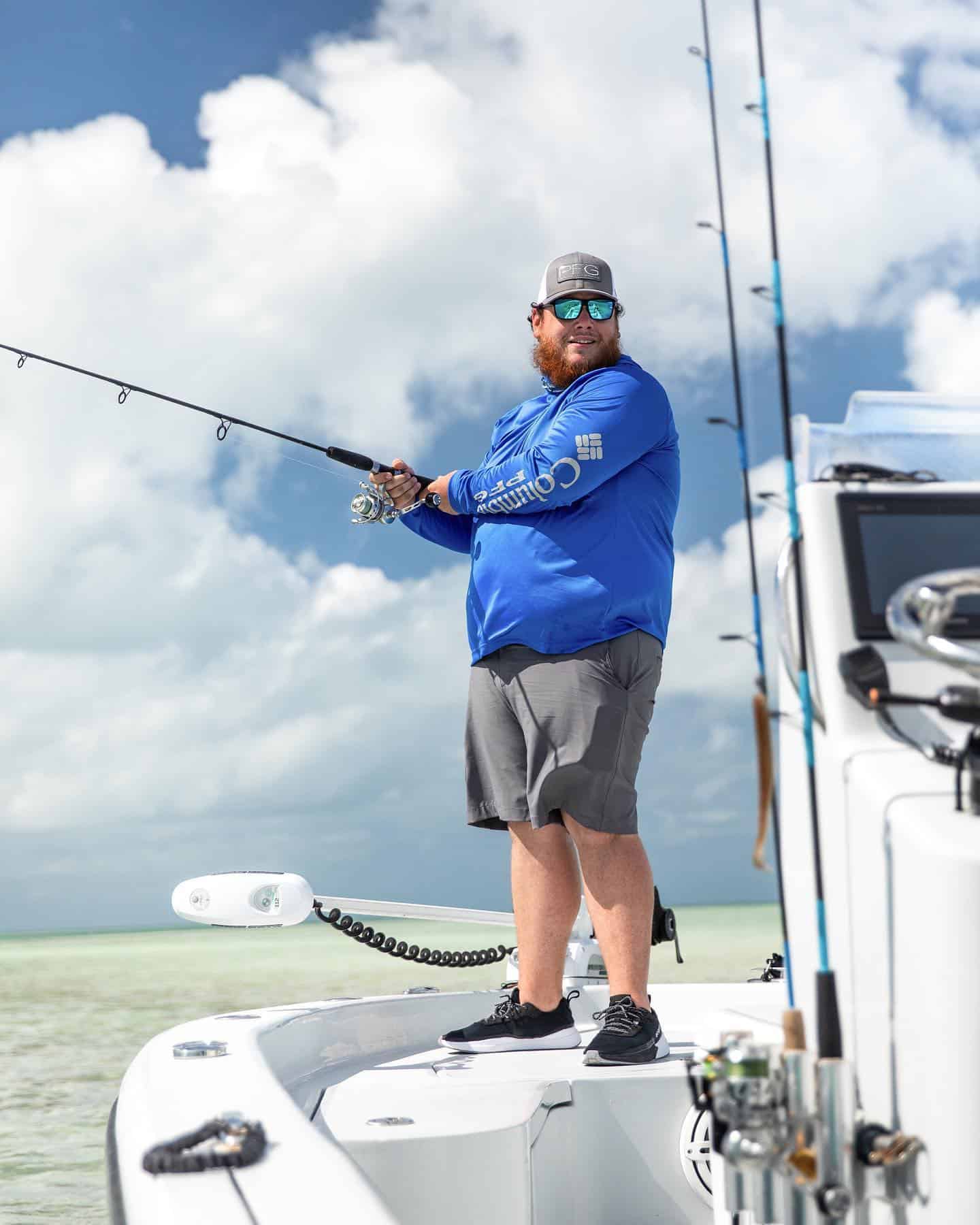 man standing on a boat fishing