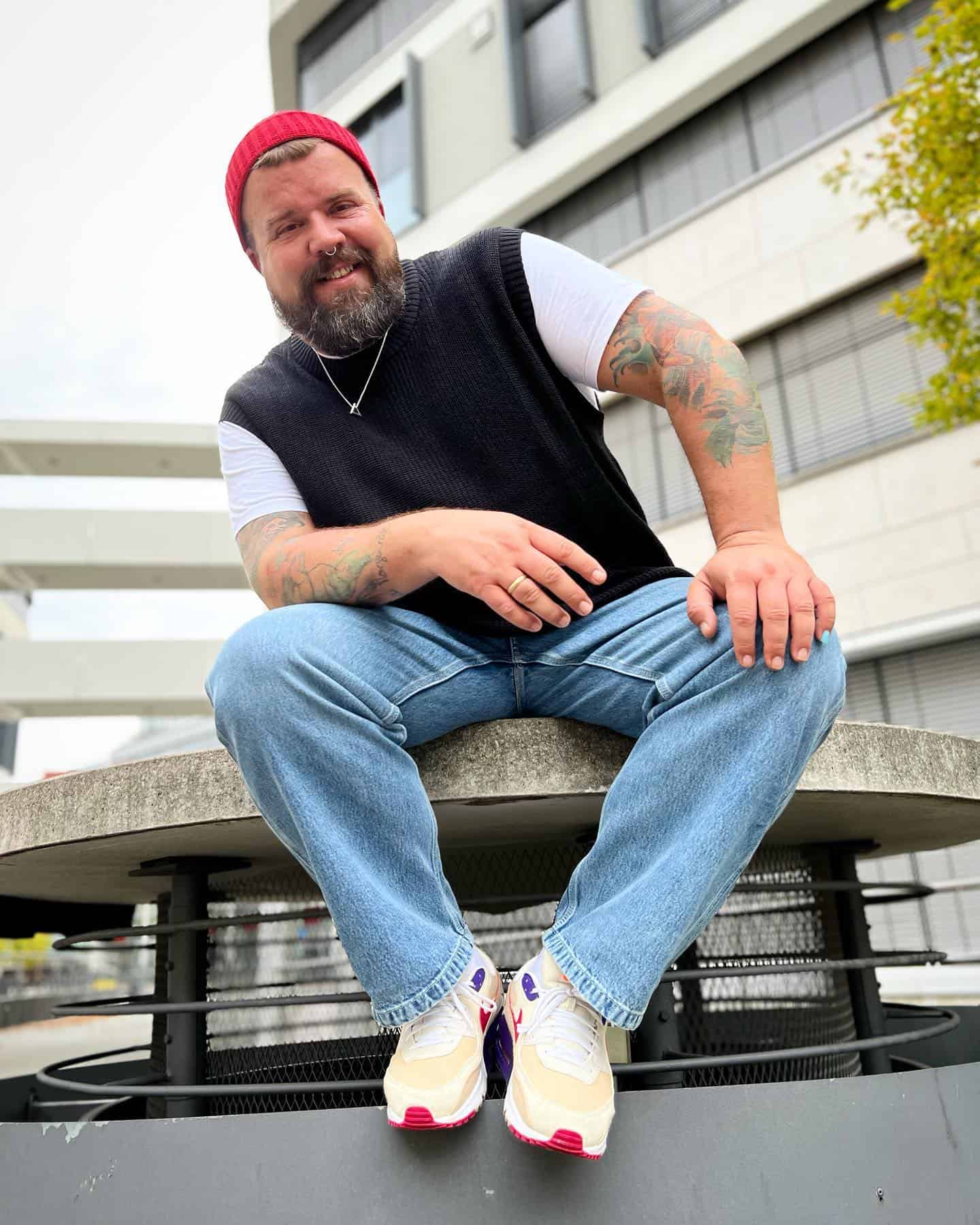 man sitting on an air exhaust