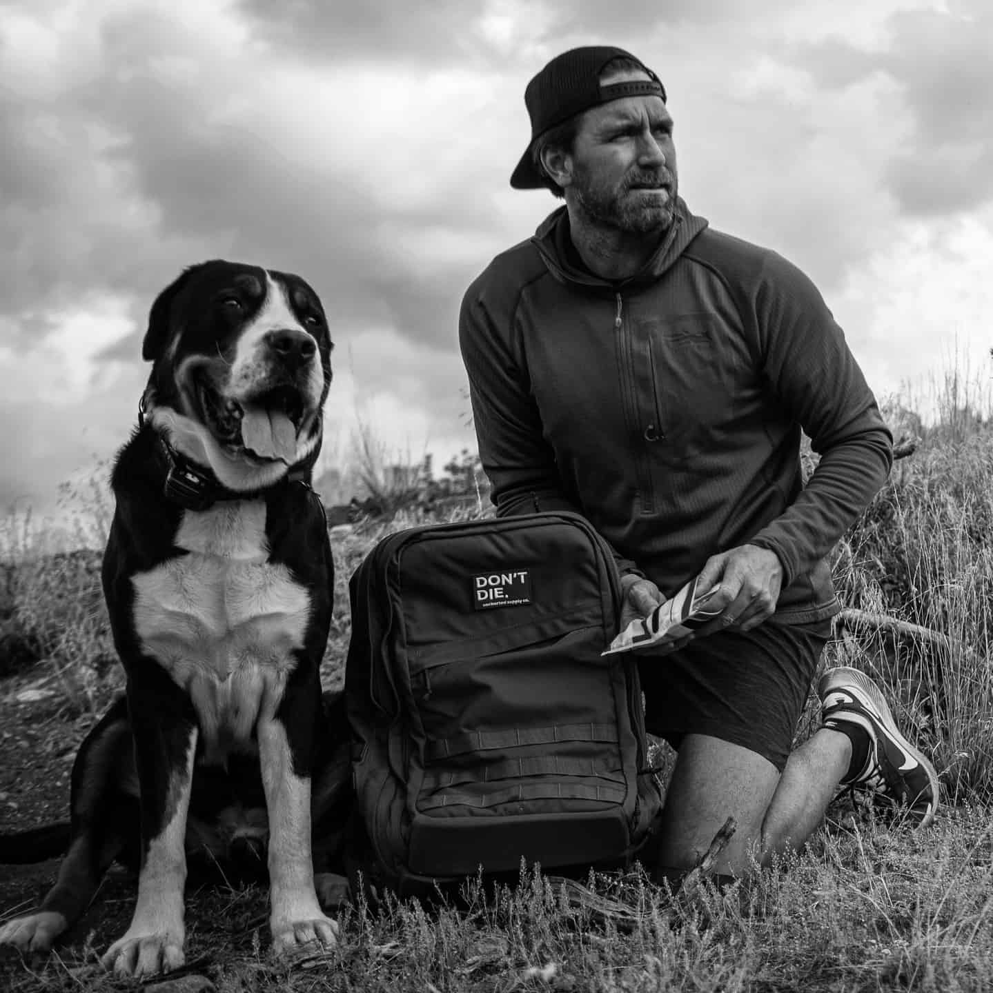 man and dog resting after a hike