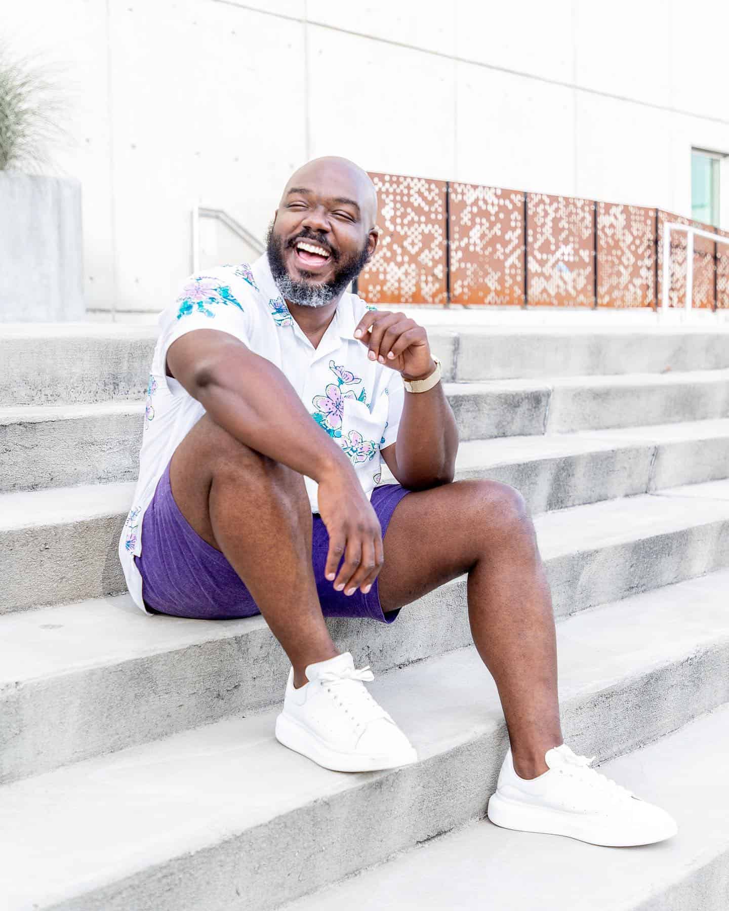 man happilly sitting at the stairs