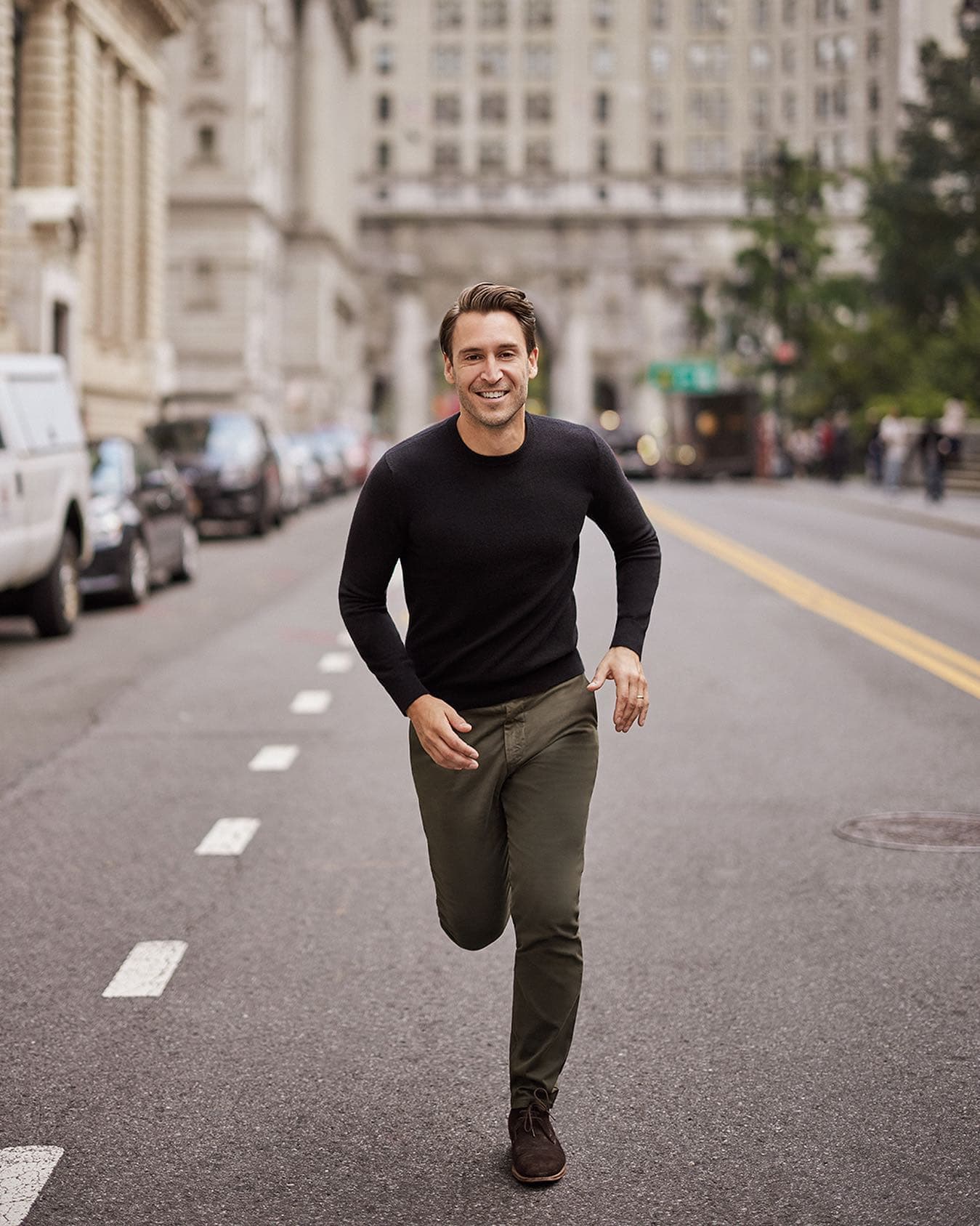 man happily running on the street