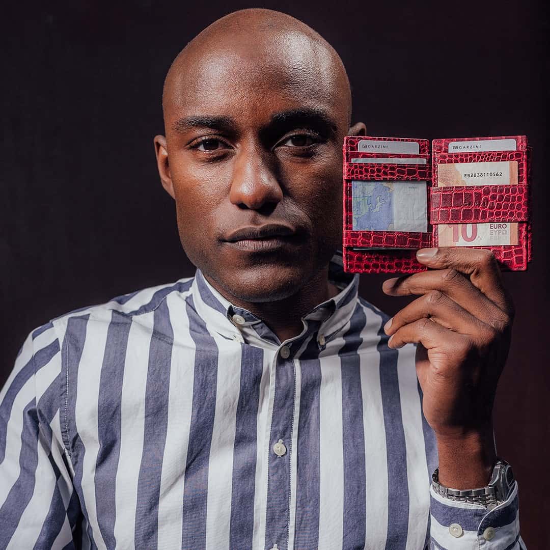 man holding a magic wallet made of croco leather