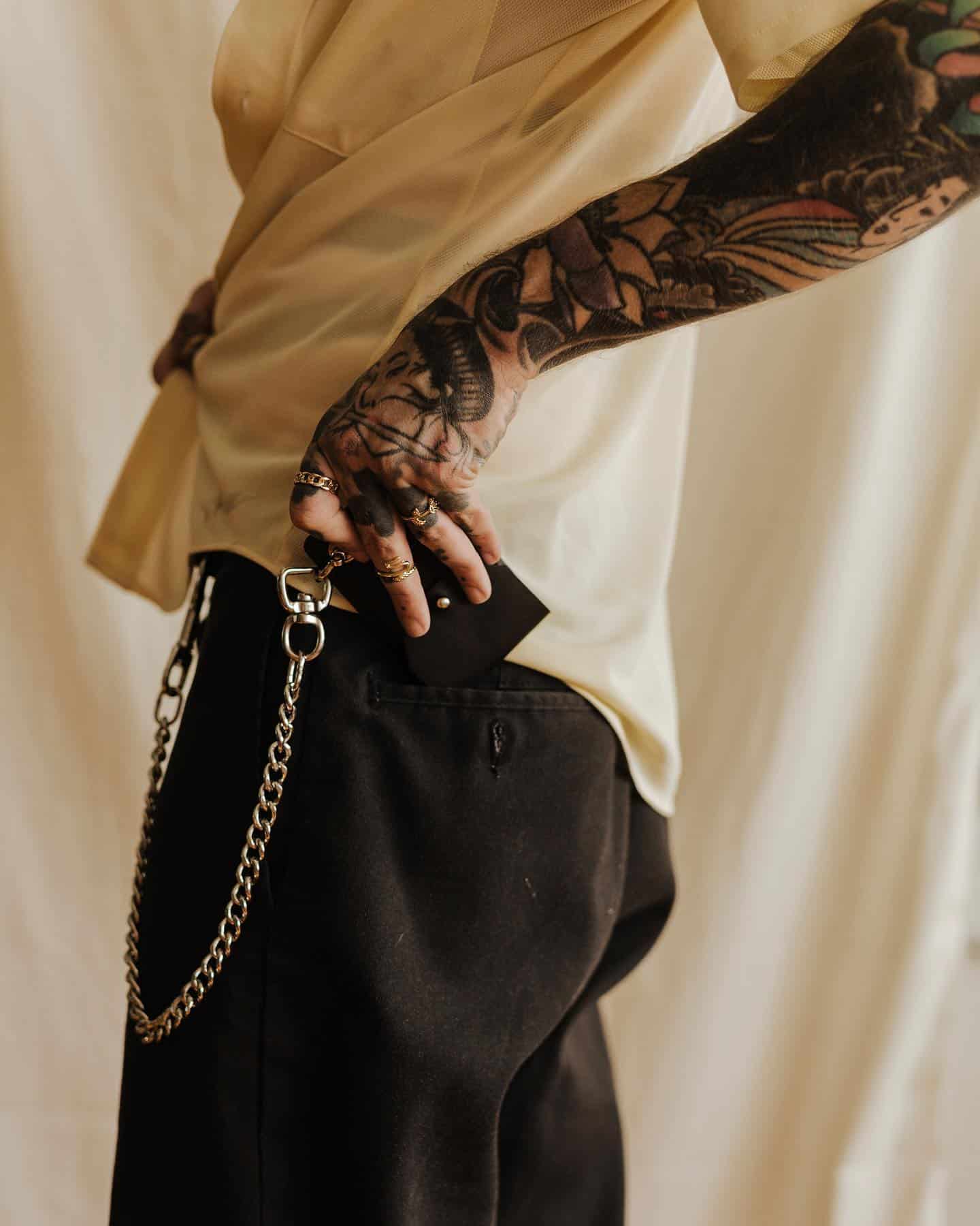 man inserting a chain wallet into pocket