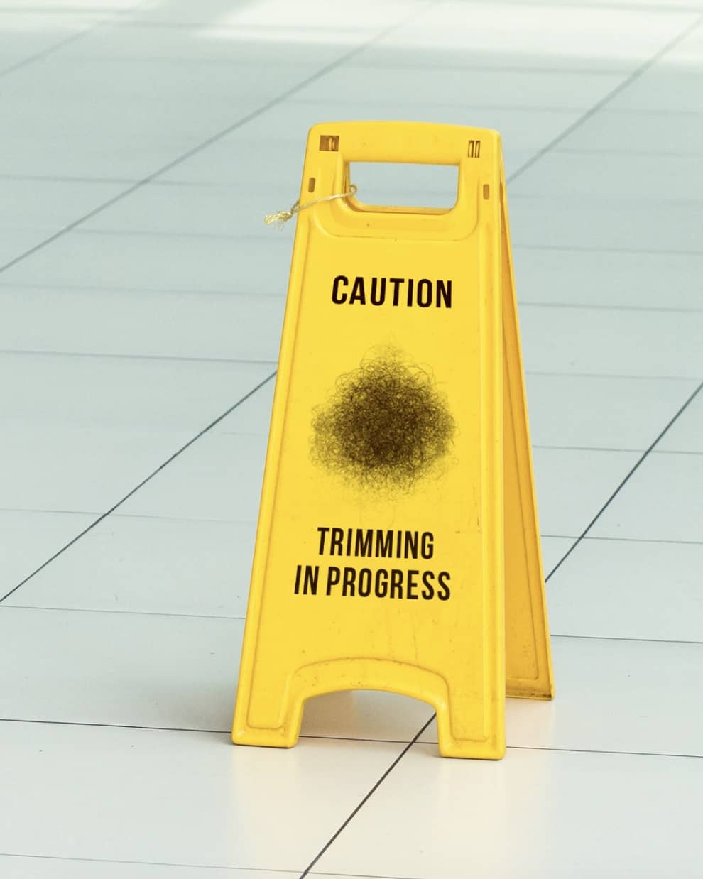 yellow caution sign that reads 'caution trimming in progress' 