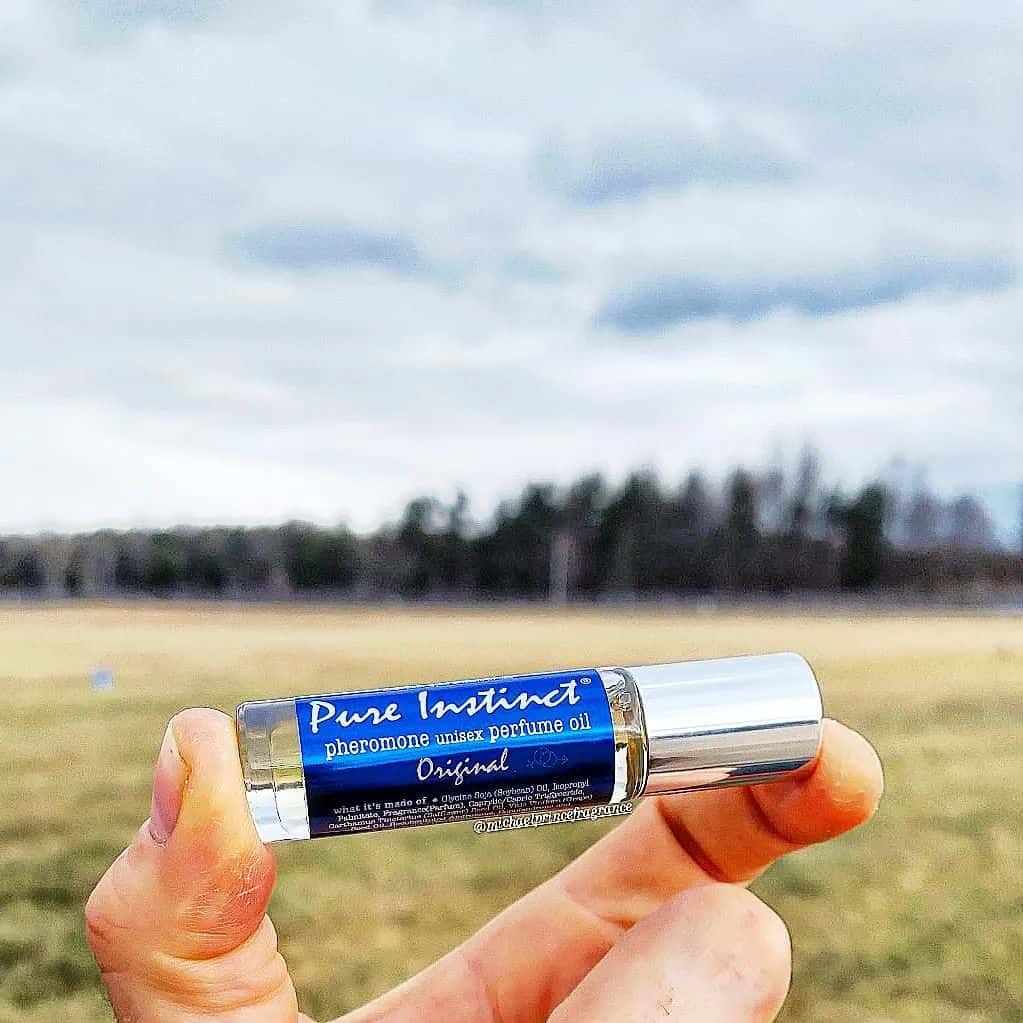 holding a bottle of pheromone perfume by pure instinct
