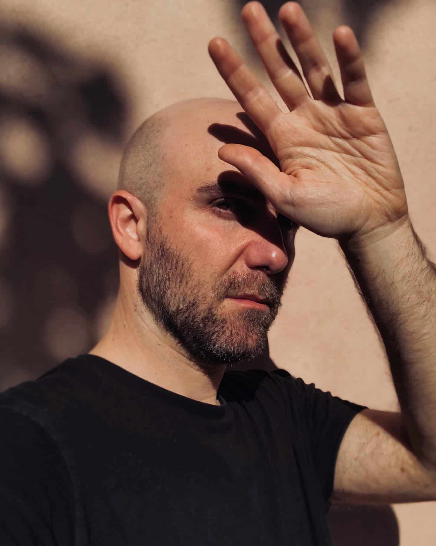 man covering his face from the sun