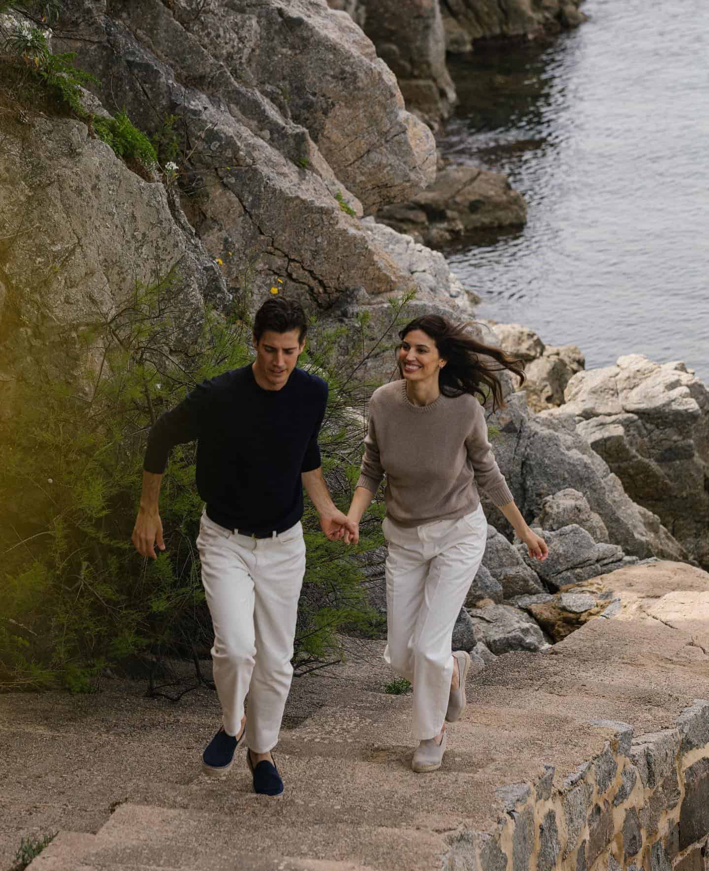 couple running up the stairs while holding hands