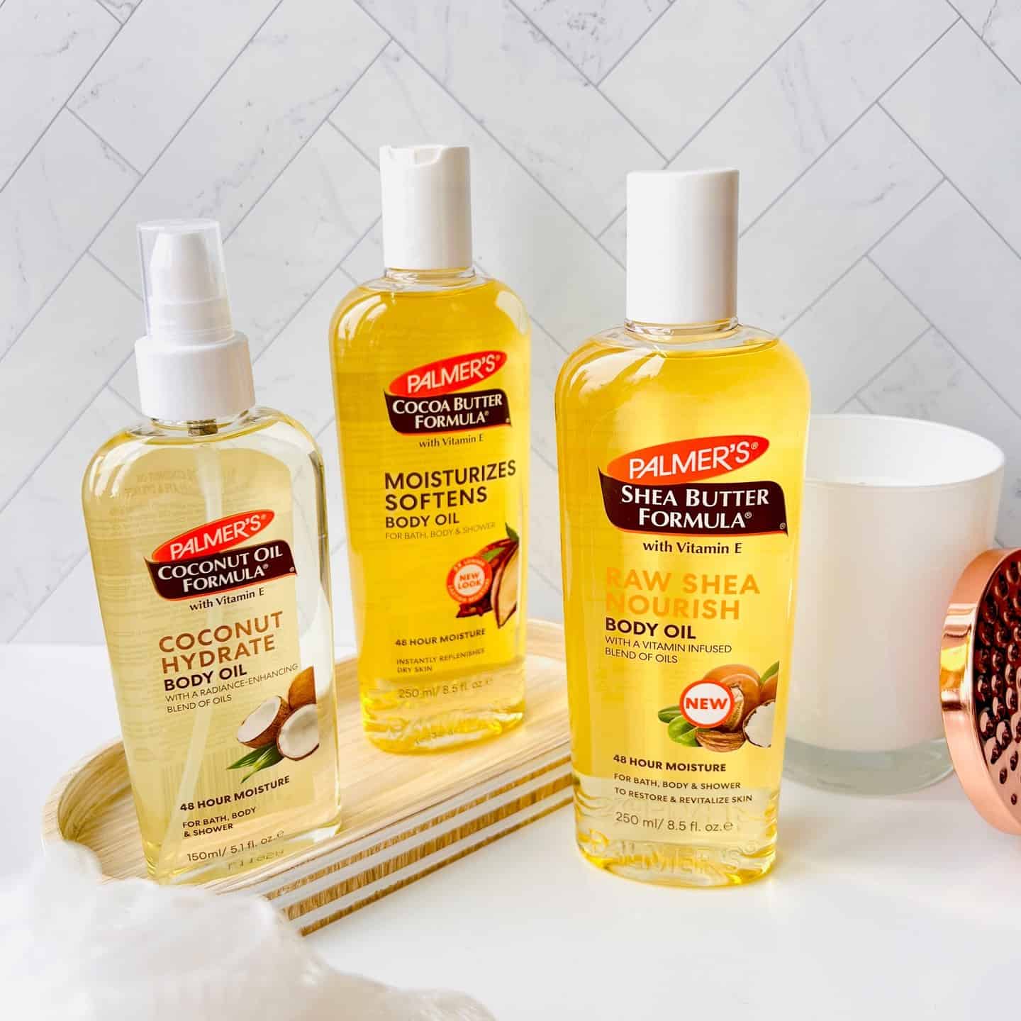 three different bottles of body oil by palmer's