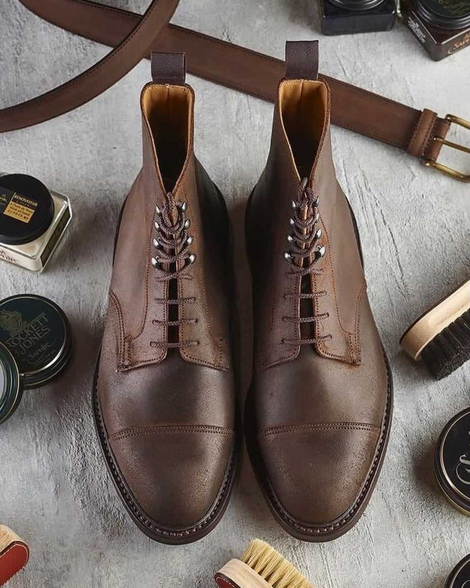 a pair of leather boots surrounded with leather cleaning essentials