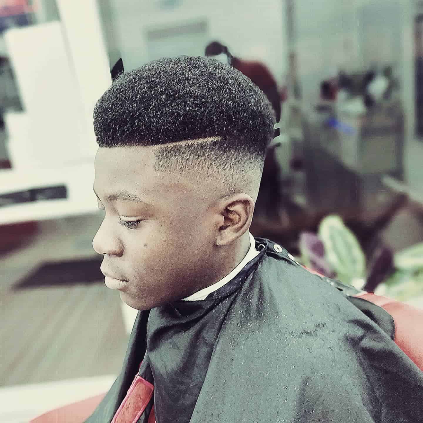 young man getting the haircut number 5 with skin fade