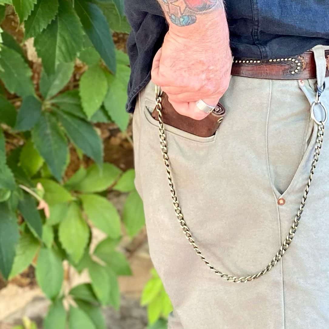 man pulling out a chain wallet