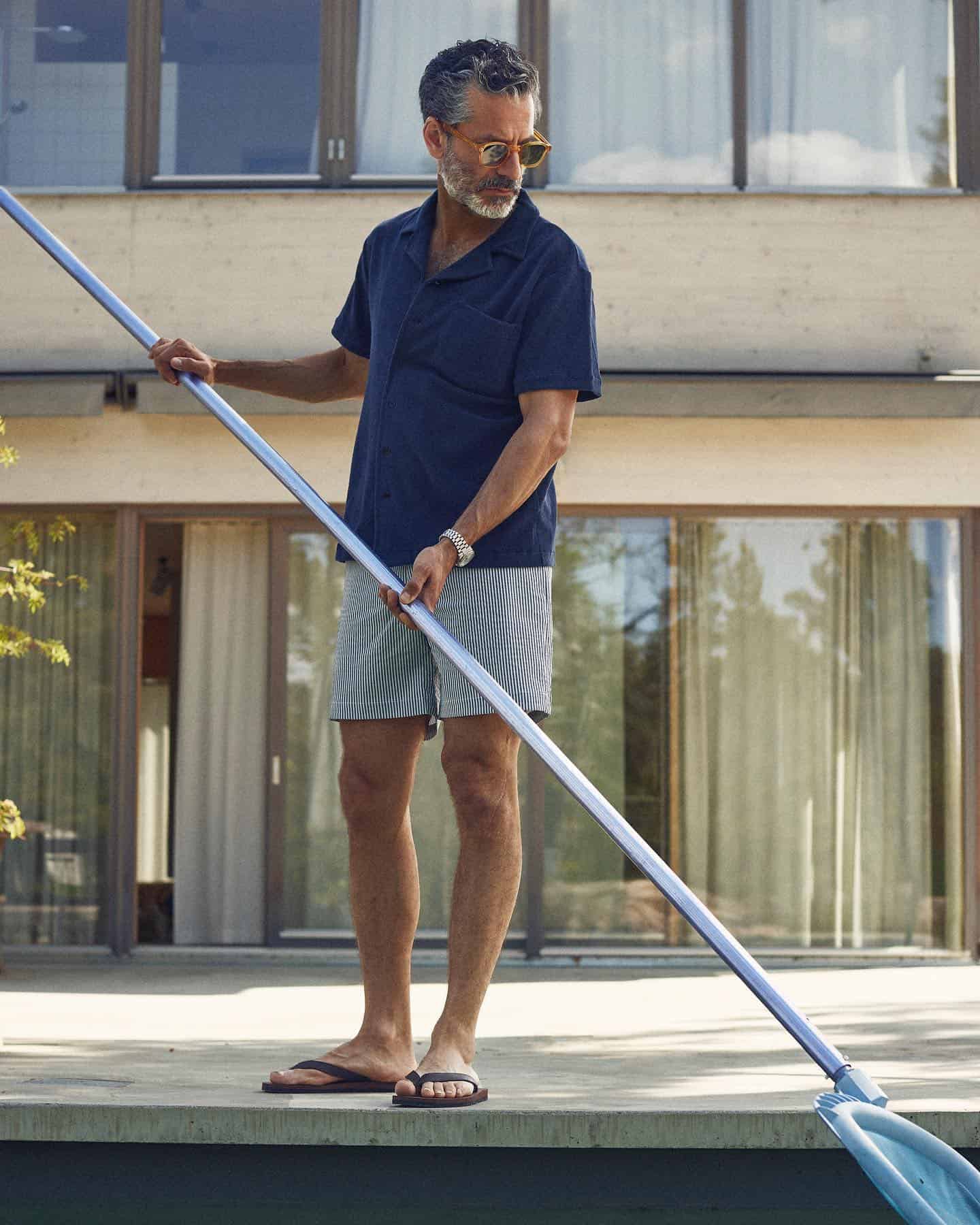 man cleaning the pool