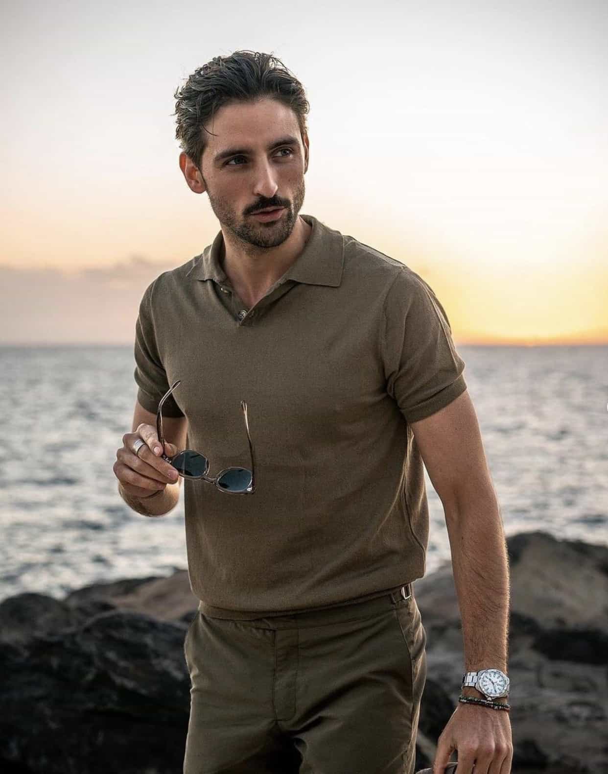 man wearing green khaki pants by the beach