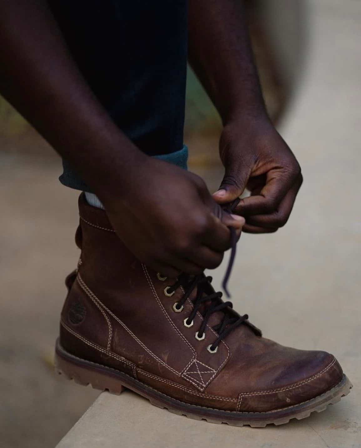 tying a shoelace of a boot