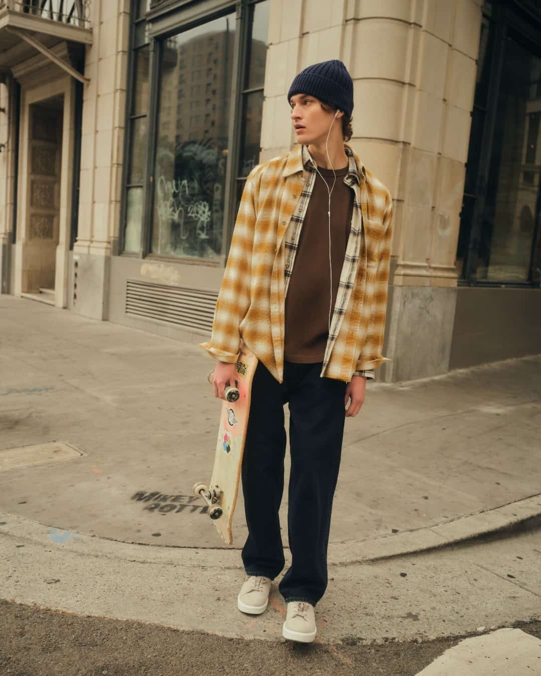 young man carrying a skateboard