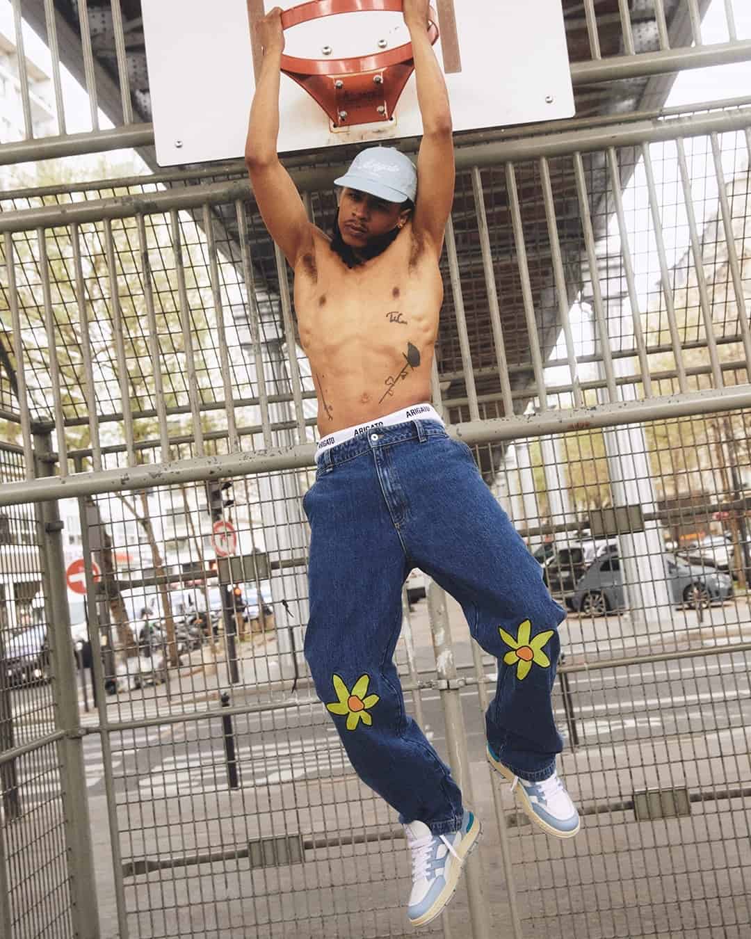 man hanging on the basketball ring