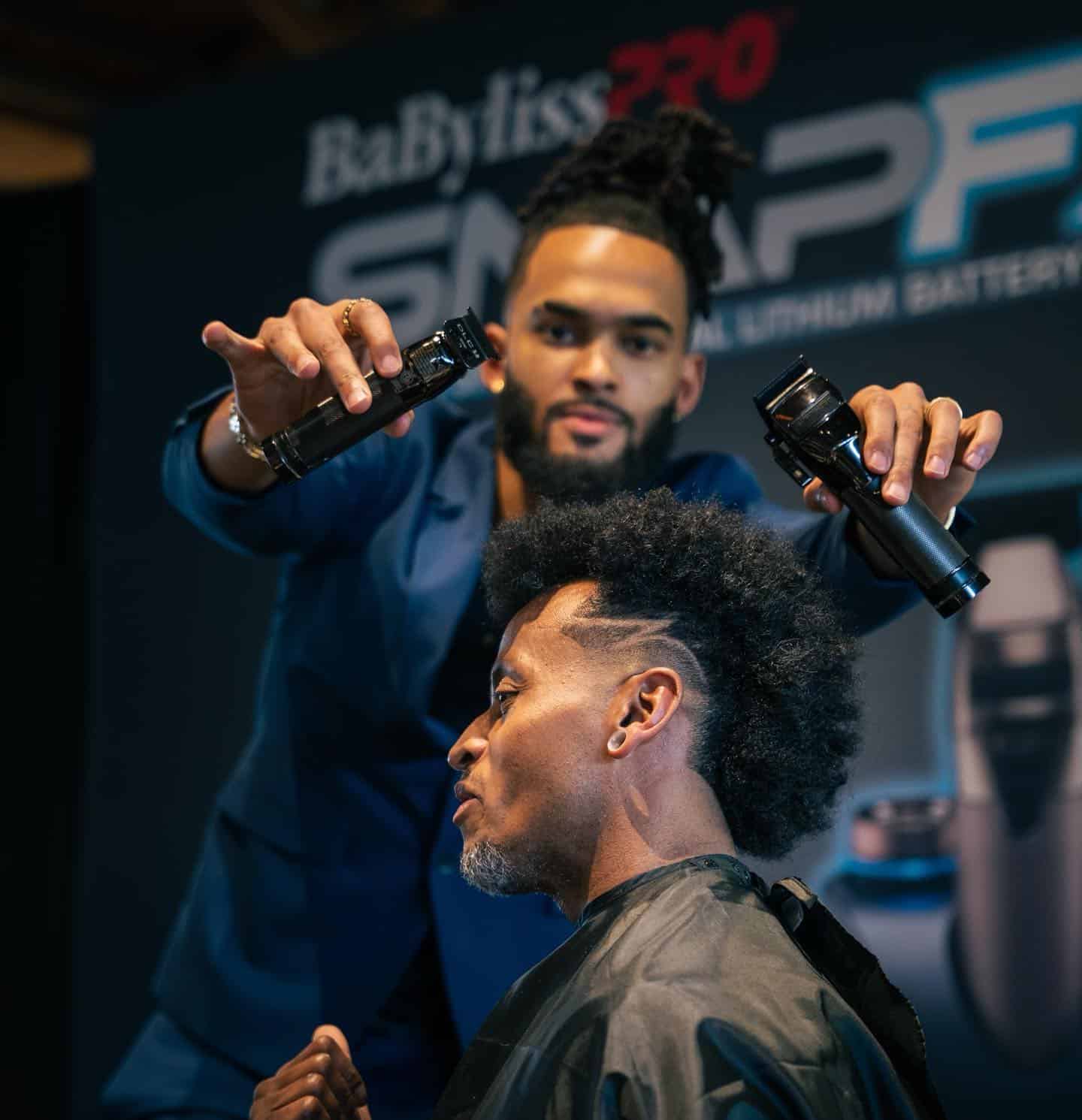barber holding out two babyliss snap fx clippers