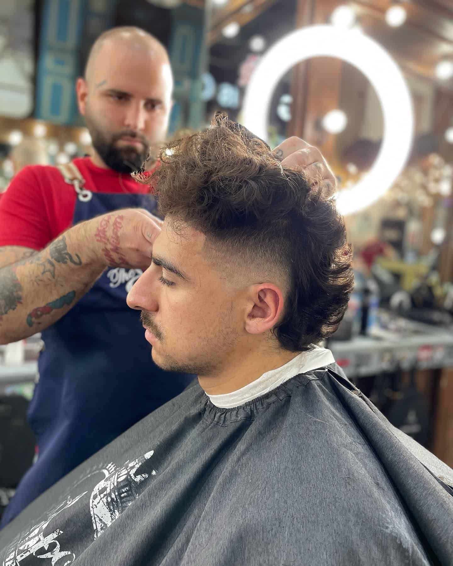 man with messy hair getting a haircut