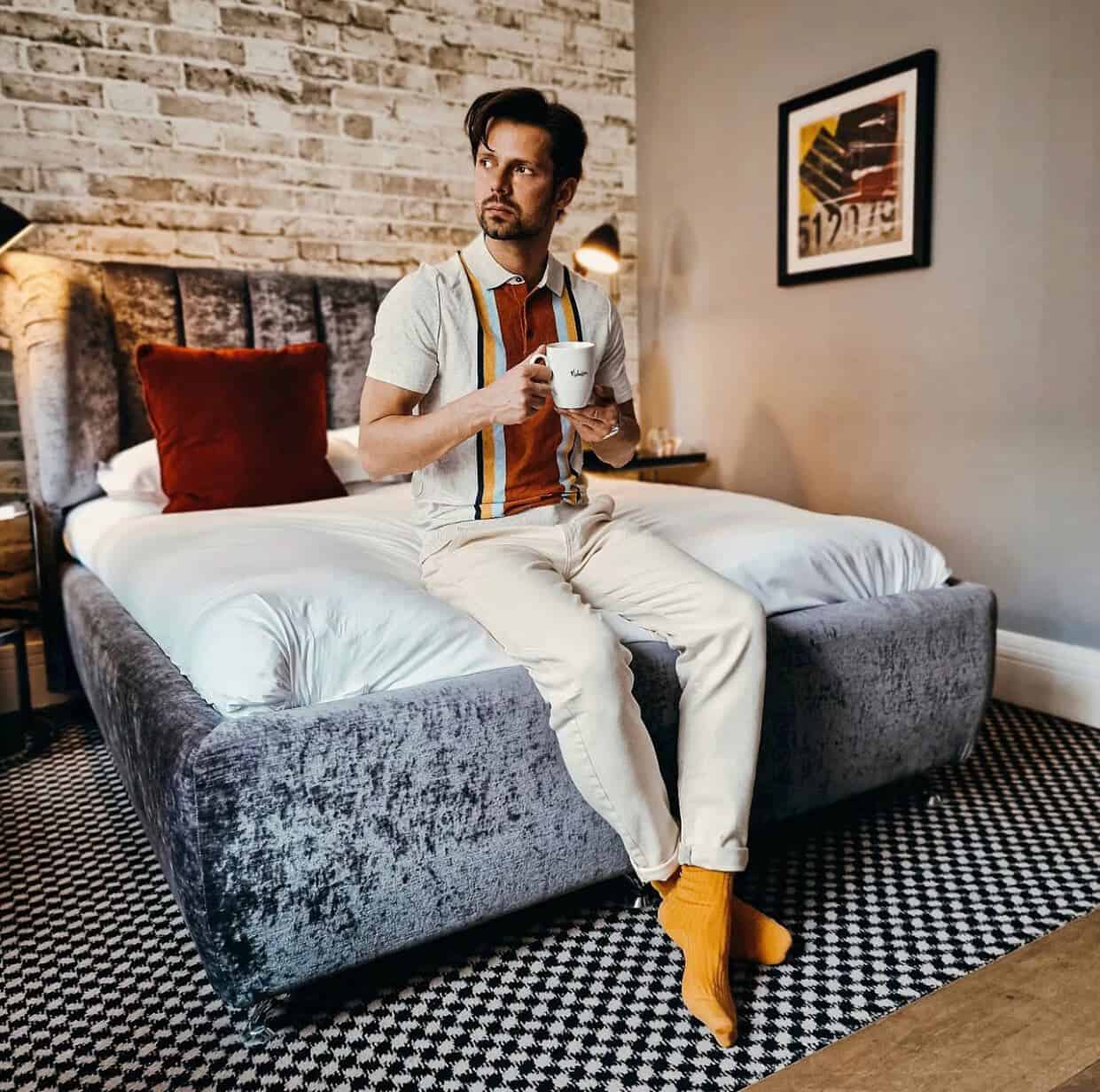 having a cup of coffee on the bed