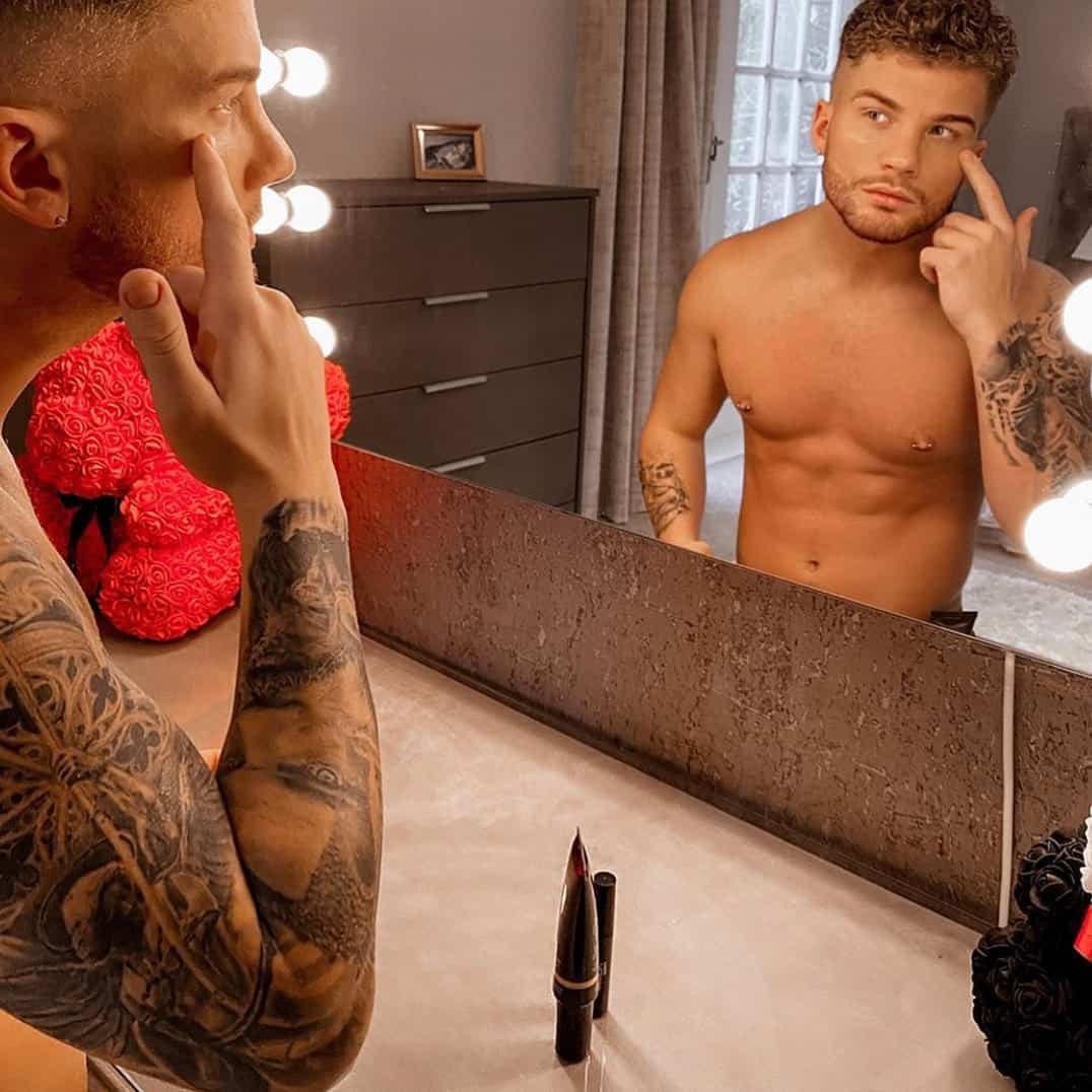 man checking face in the mirror