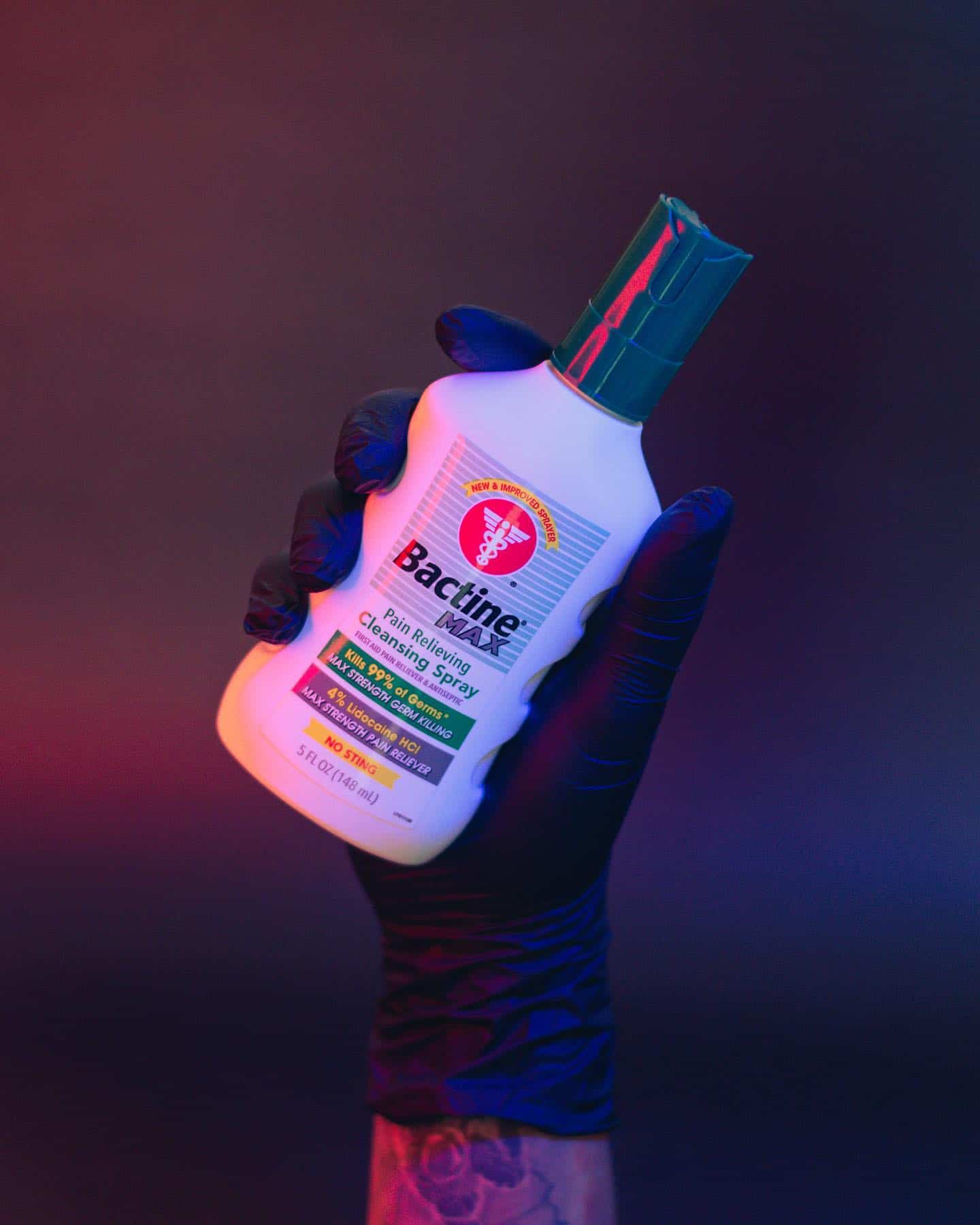 holding a bottle of bactidine max