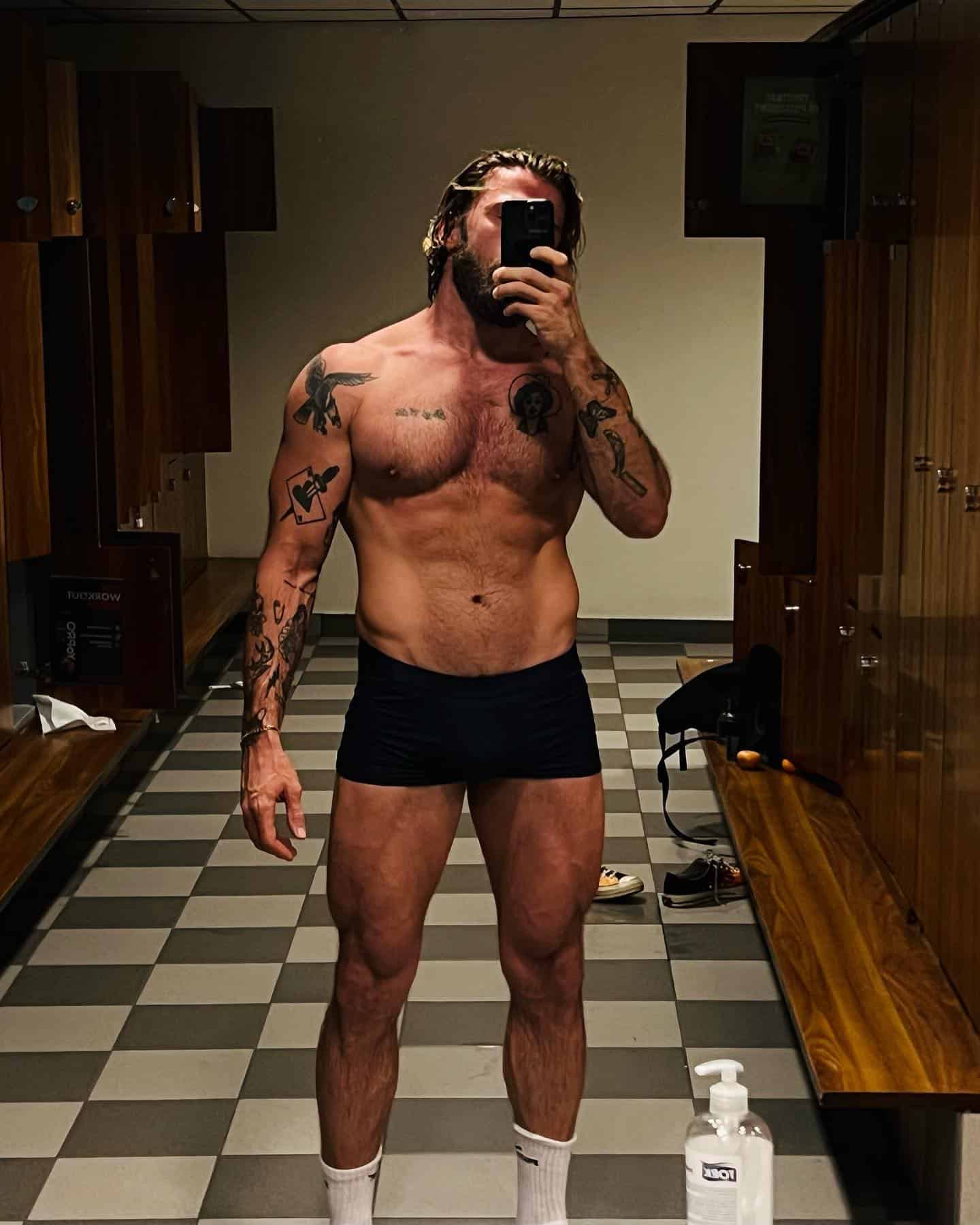 man taking a selfie in a locker room