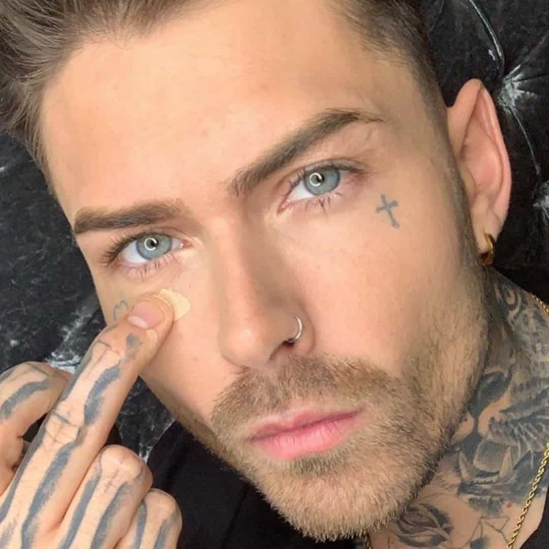 man concealing face tattoo