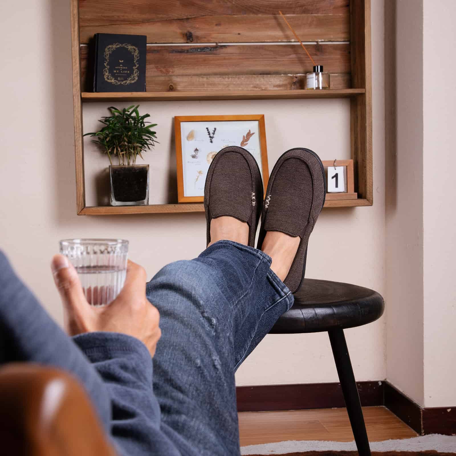 man resting foot on top of a stool