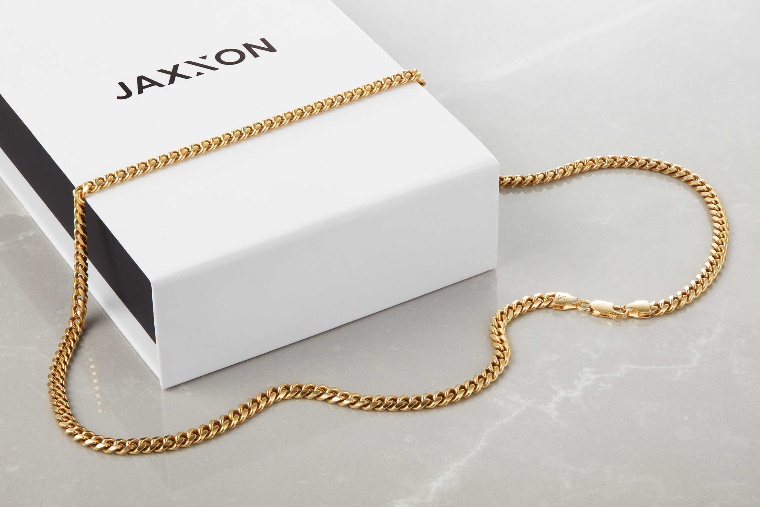 Jaxxon Cuban chain over a box