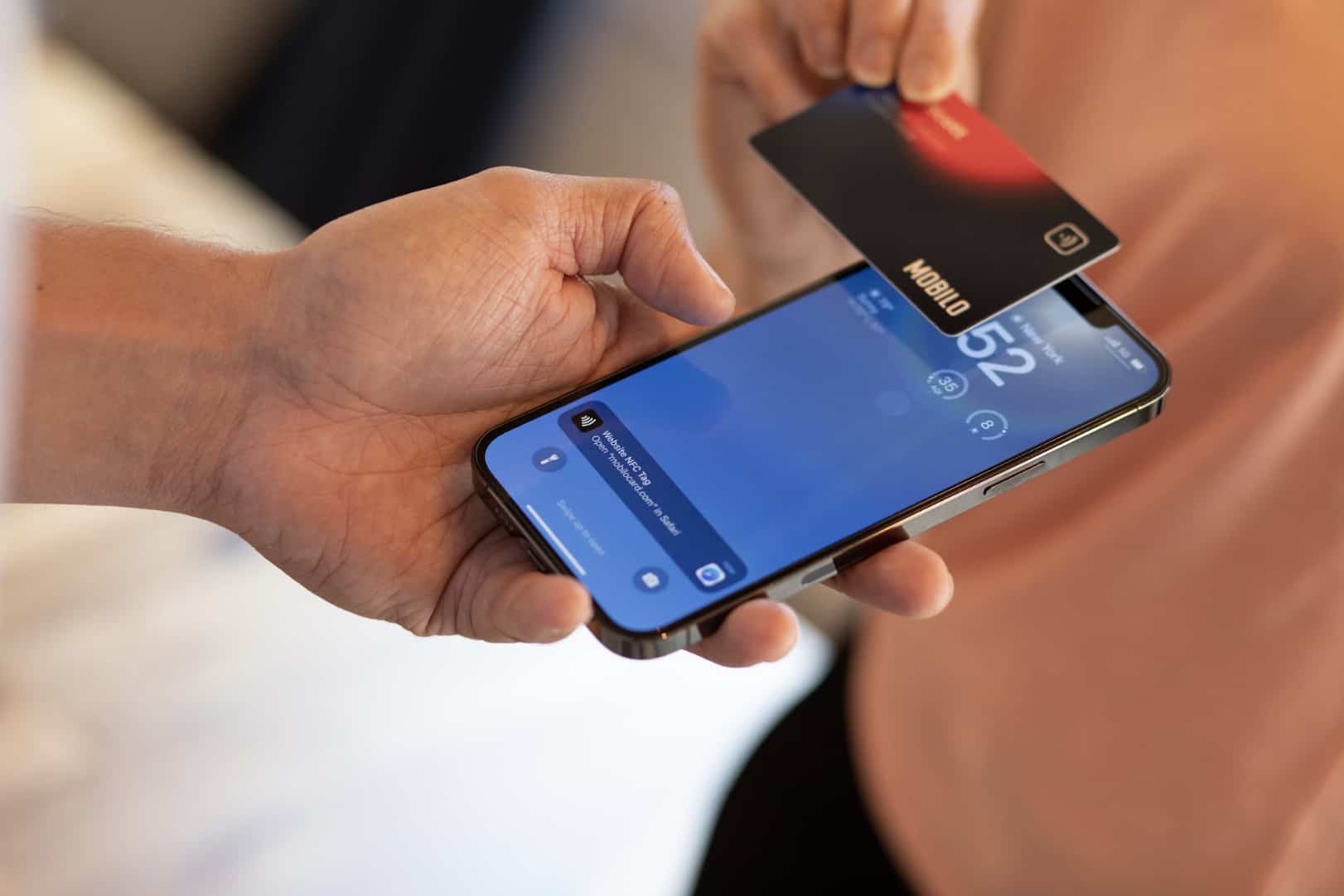 close up of two people sharing a digital business card