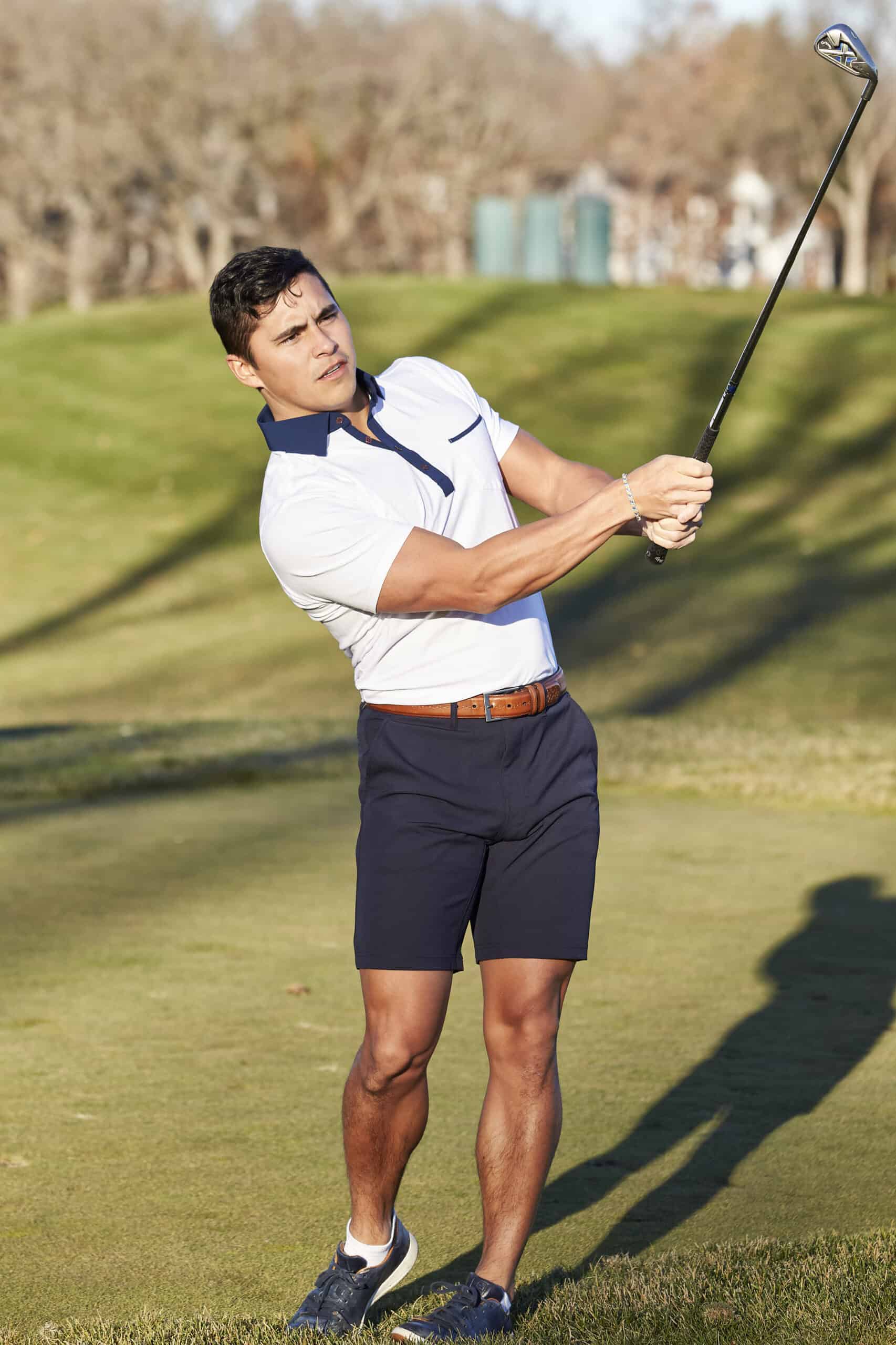 Man in golf clothes from State & Liberty, playing golf
