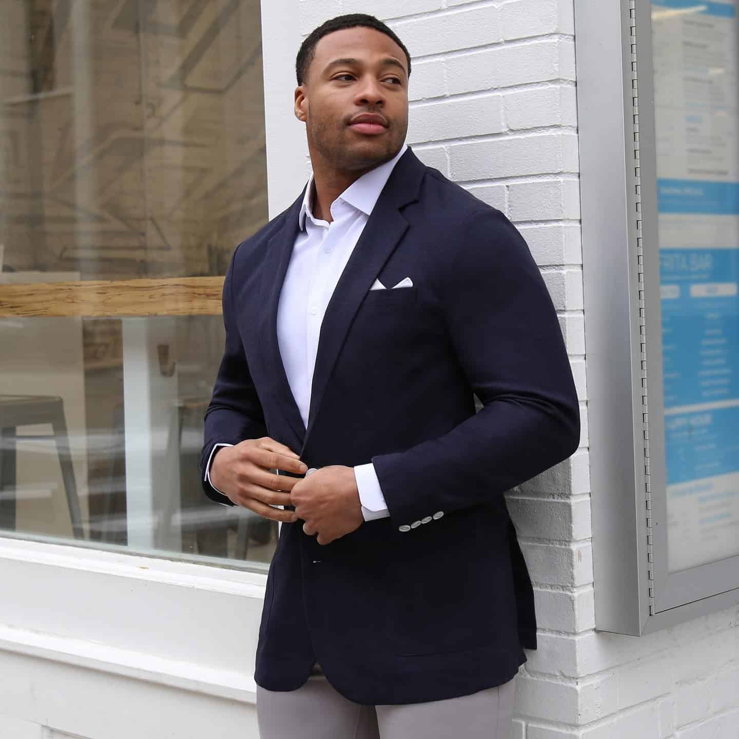Model standing outside of a store in a State & Liberty suit