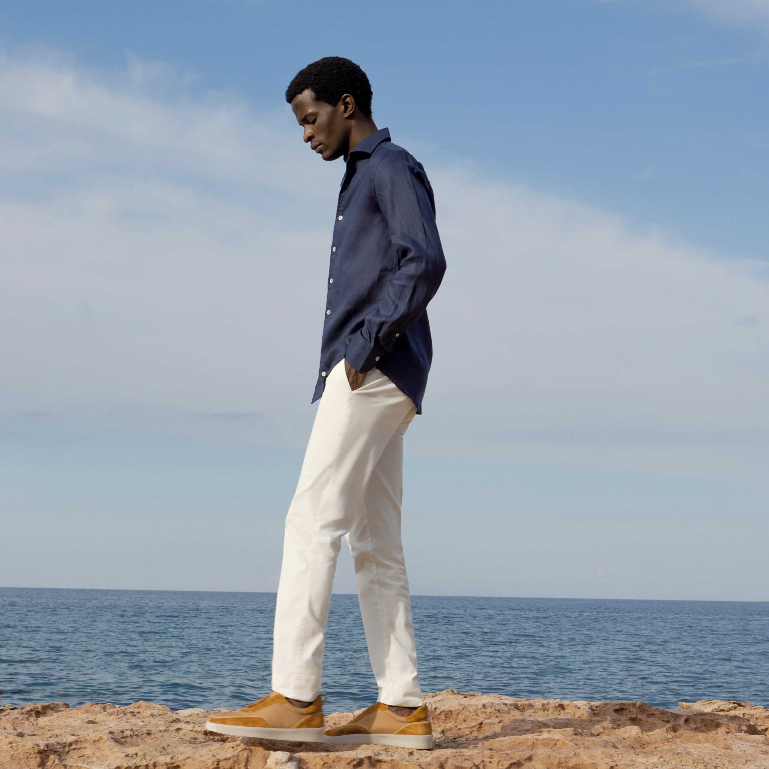 man walking by the sea