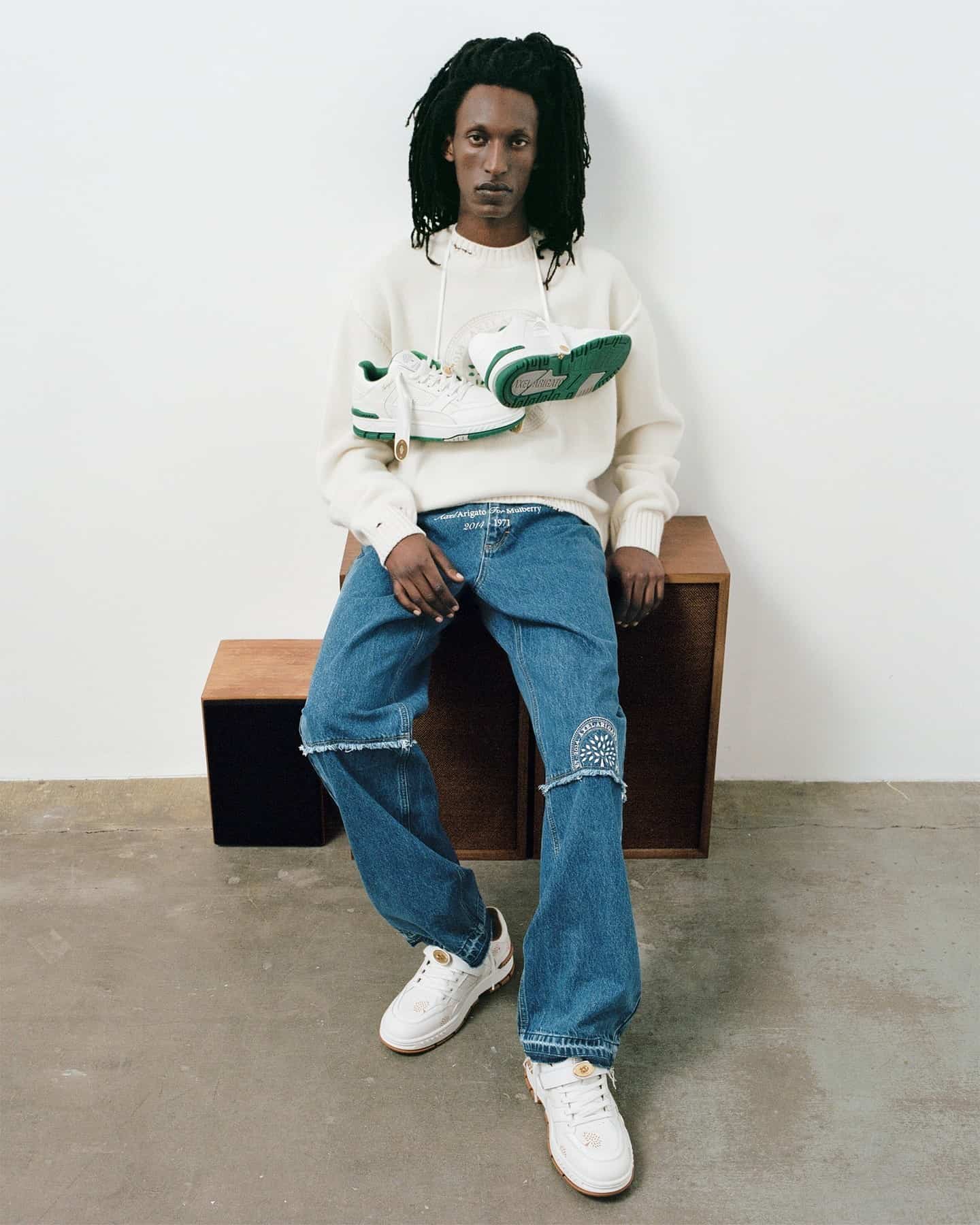 man with sneakers hanging on his neck
