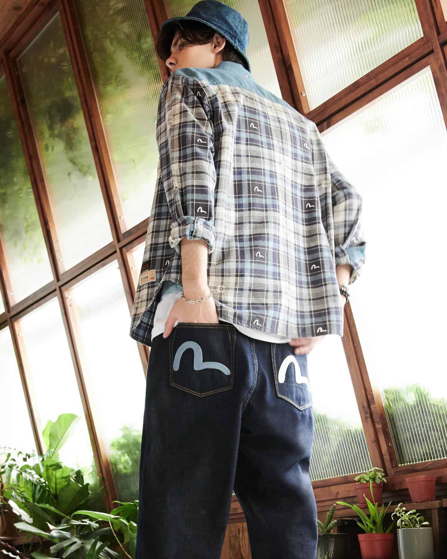 man with both hands in back pocket