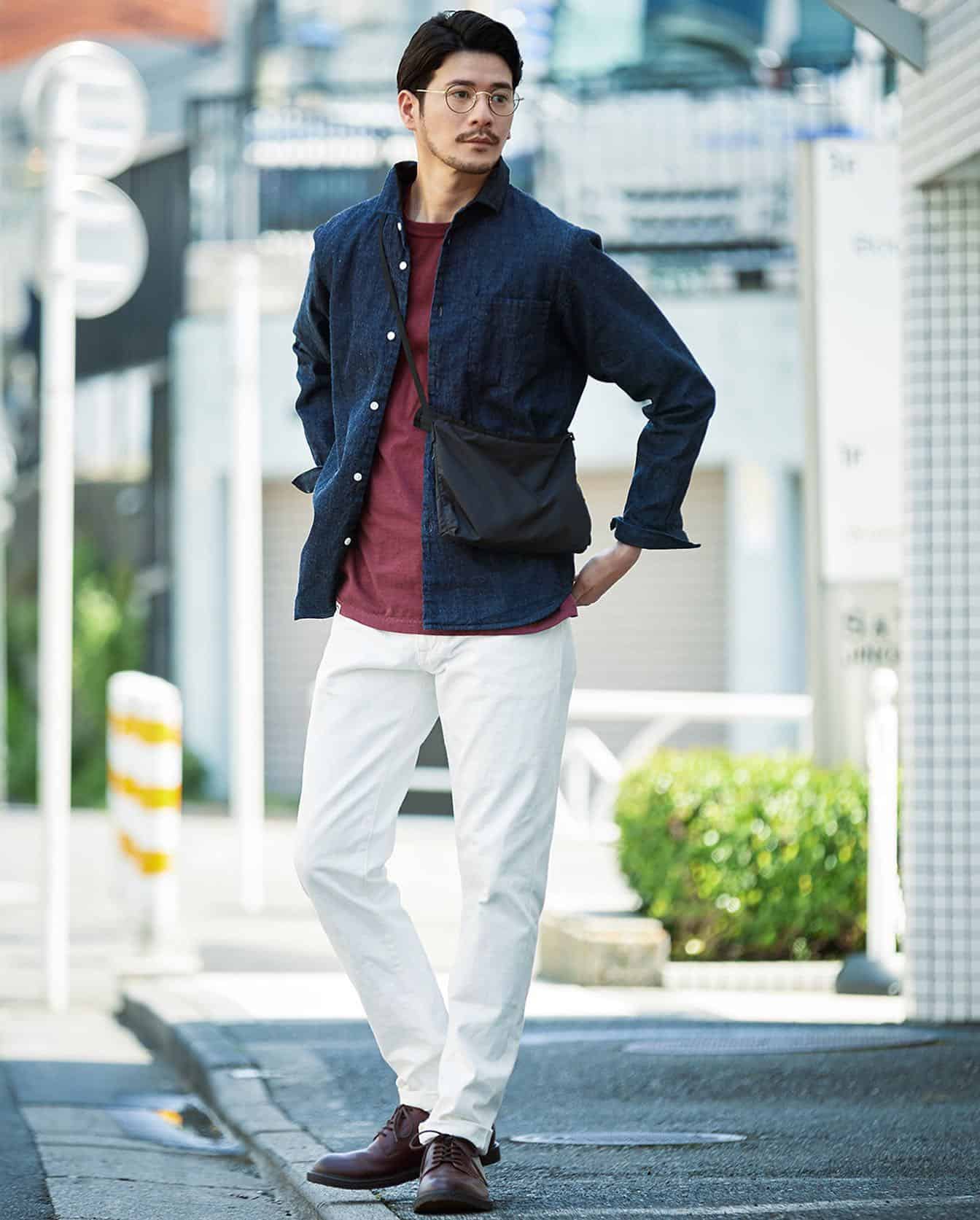 man in blue shirt and white jeans