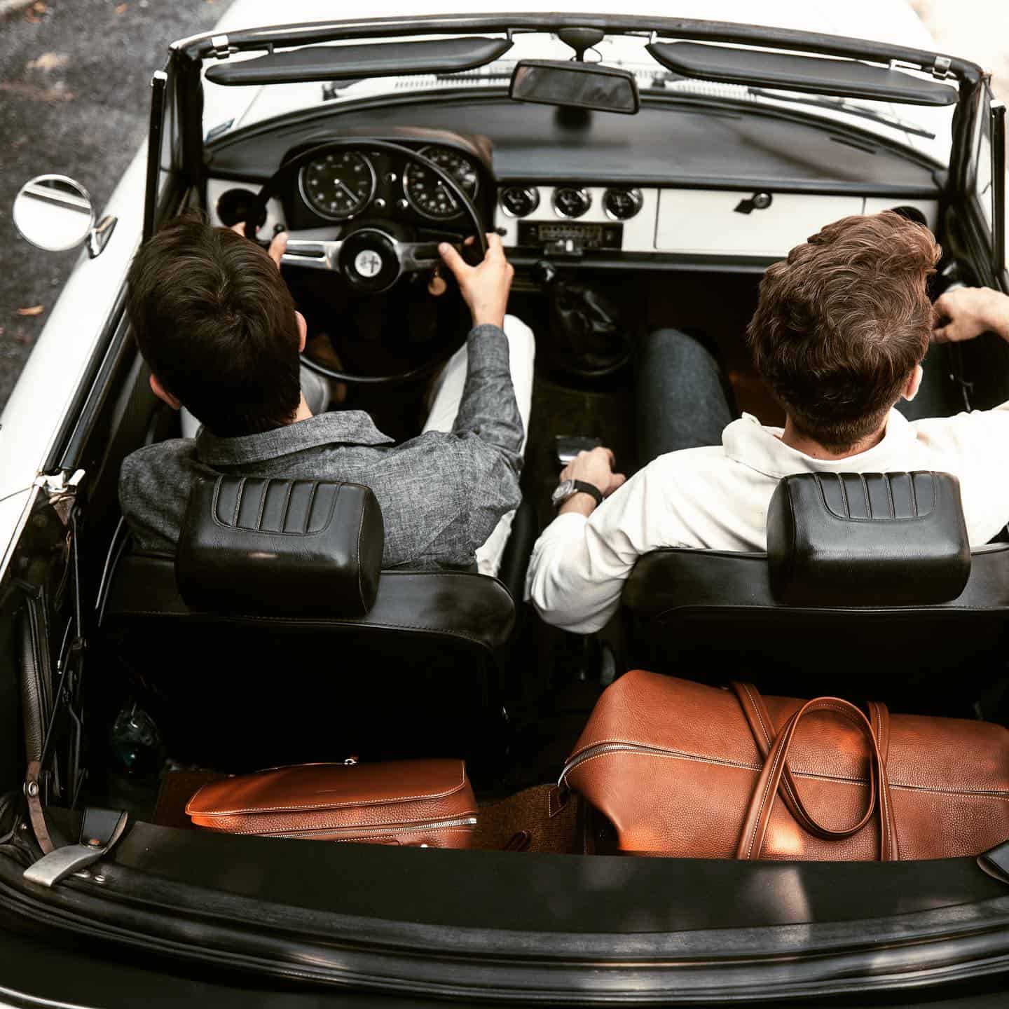 two men in a convertable